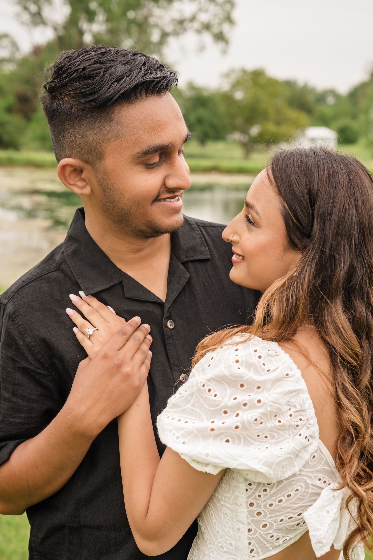 Romantic couple in black and white outfits sharing intimate moments in an outdoor photo series.