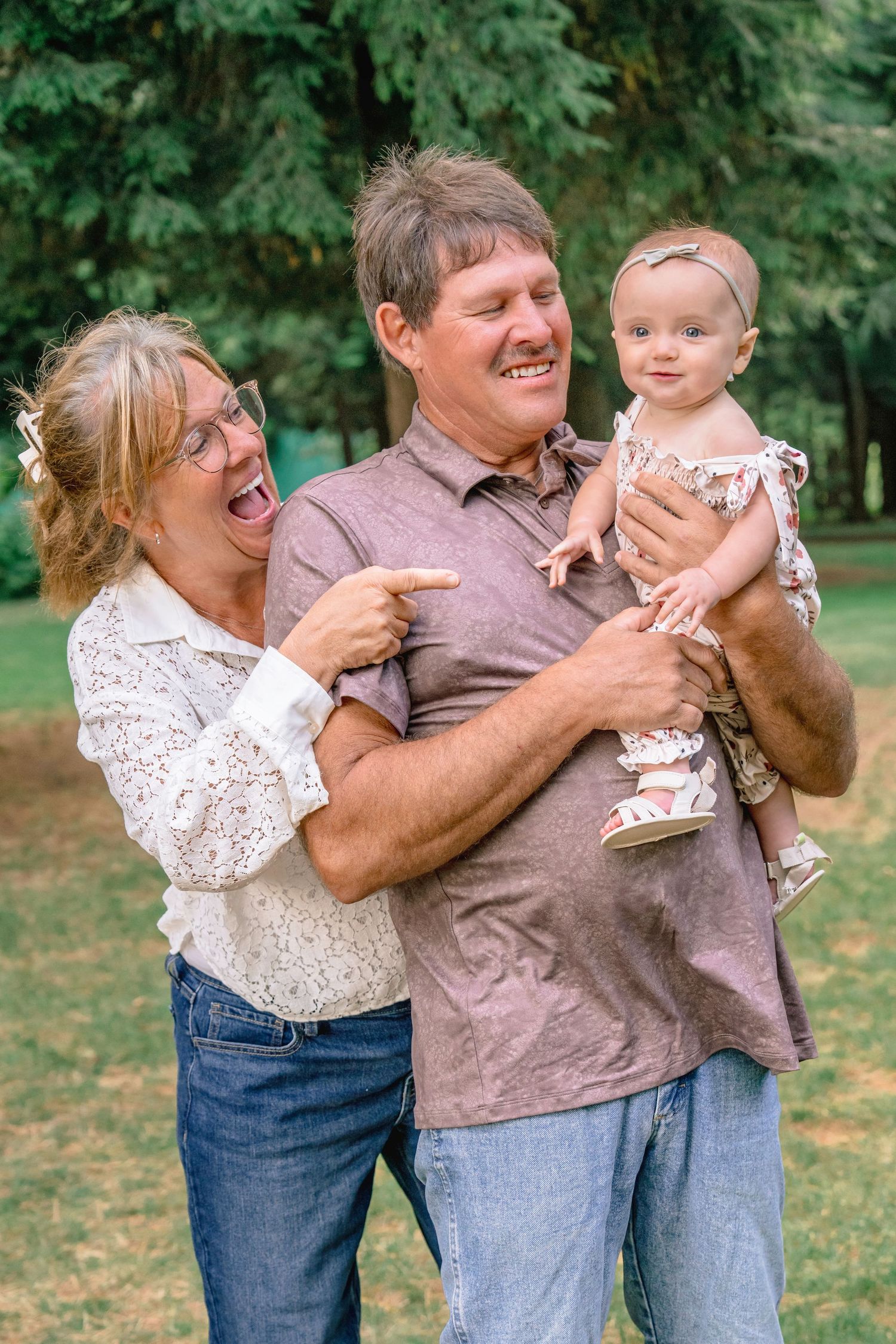 A playful family moment captured in a series of candid photos outdoors with trees in the background.