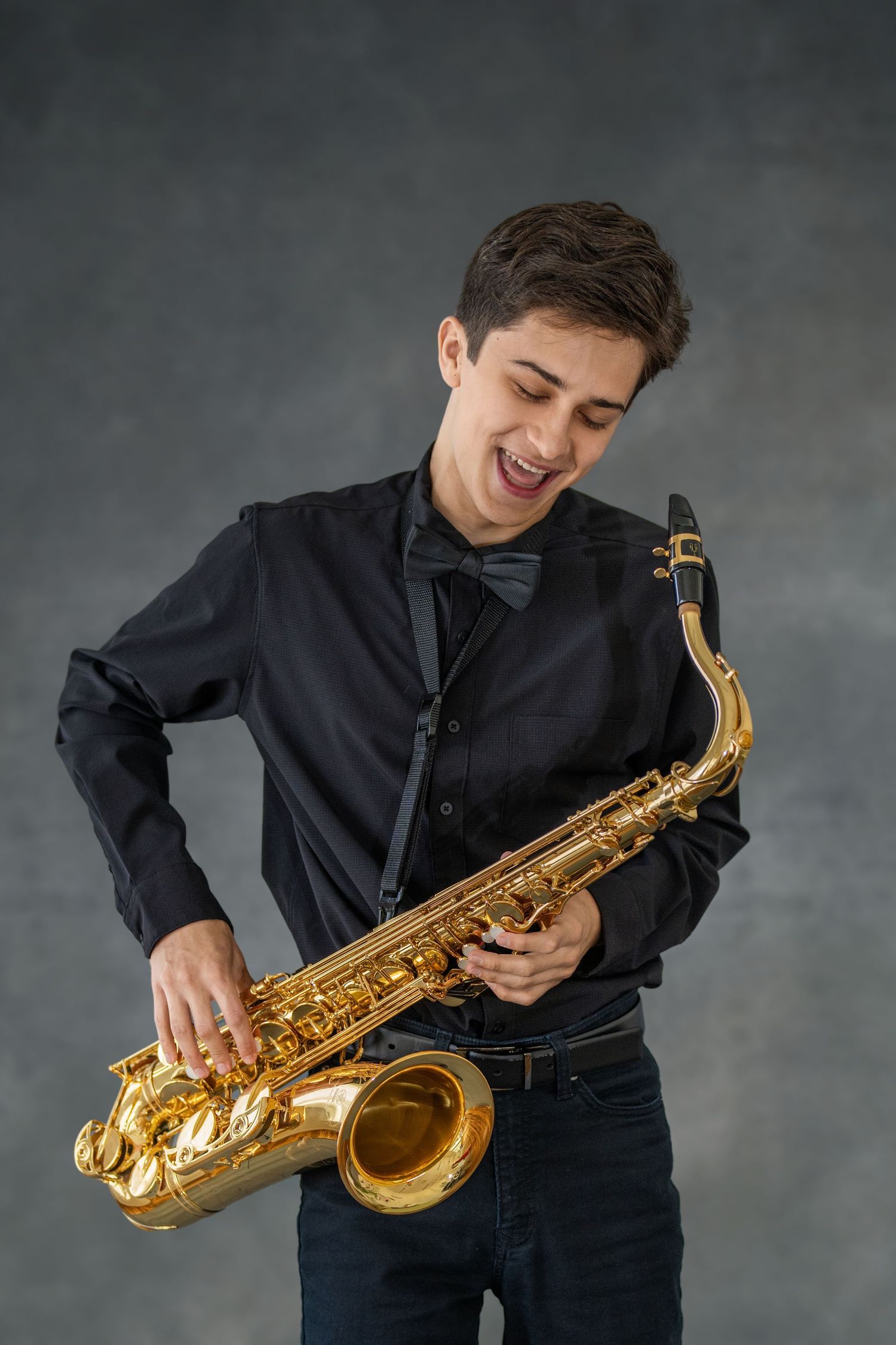 Musician in black shirt plays golden saxophone in expressive sequence of four progressive performance shots against gray backdrop.