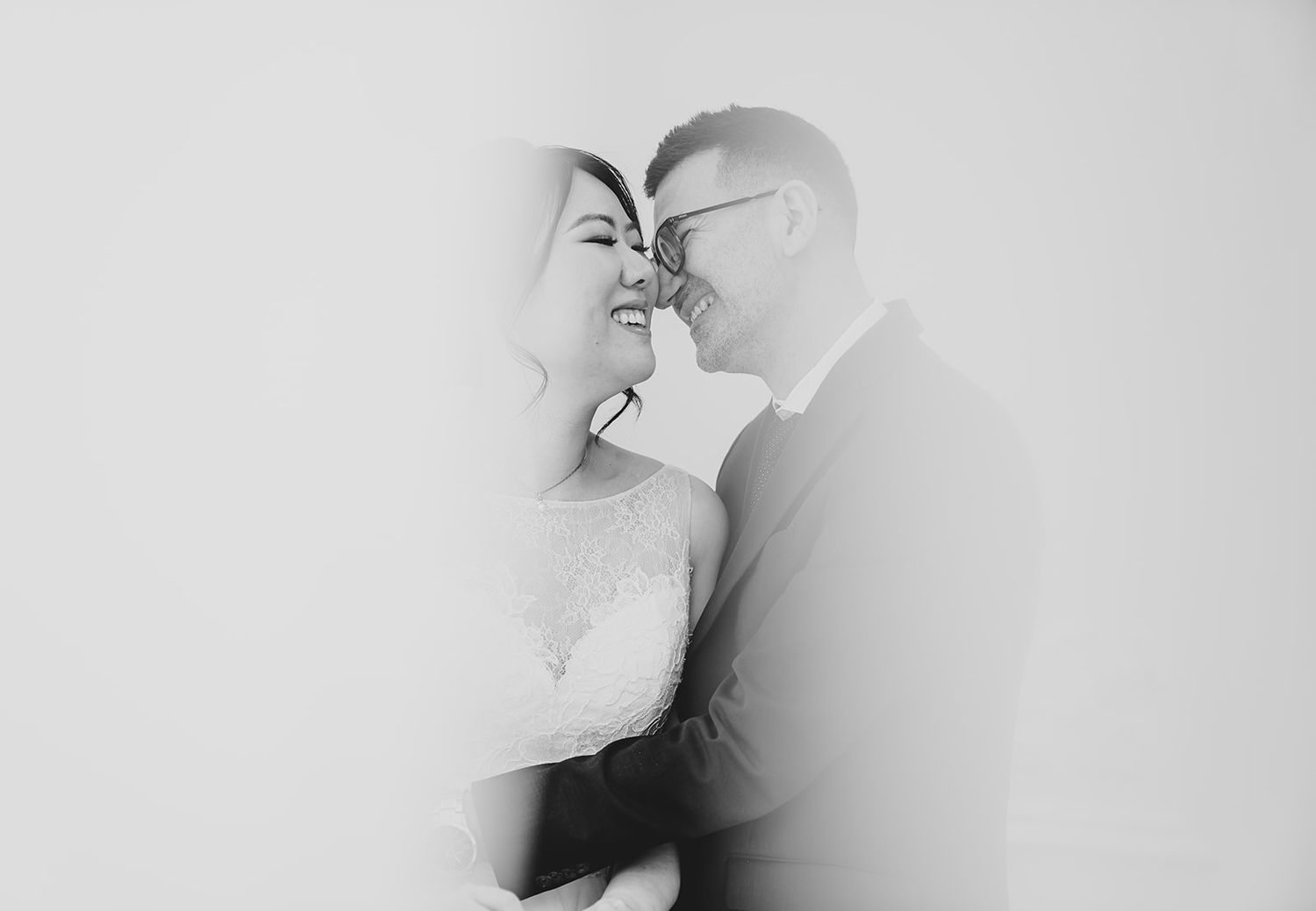 Artistic black and white close-up of couple sharing an intimate moment.