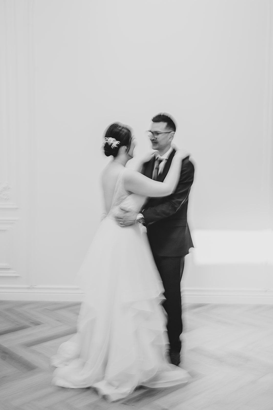 Black and white artistic wedding dance photo showing couple in intimate pose.