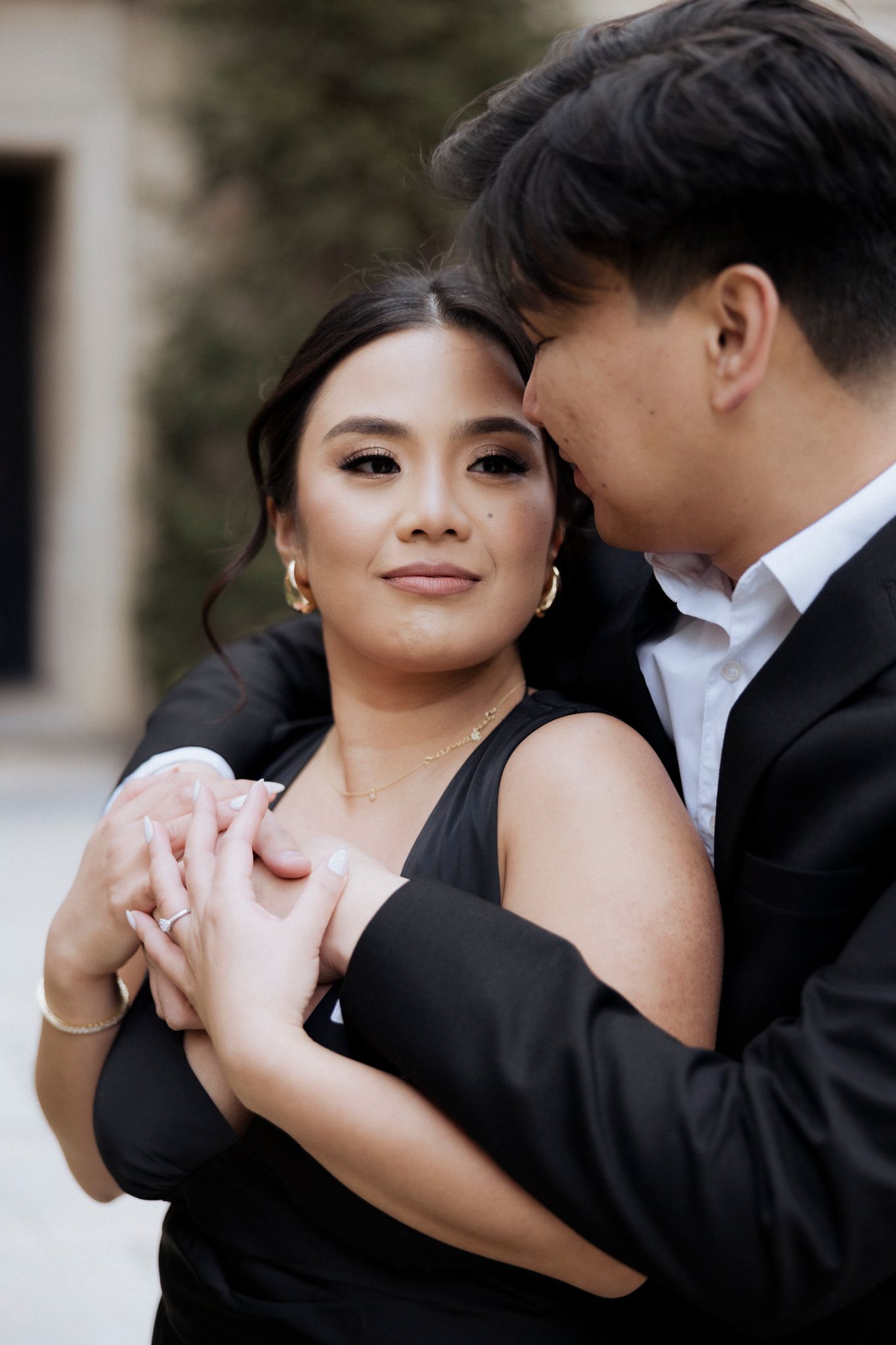 Elegant couple in formal attire sharing an intimate moment while dancing.