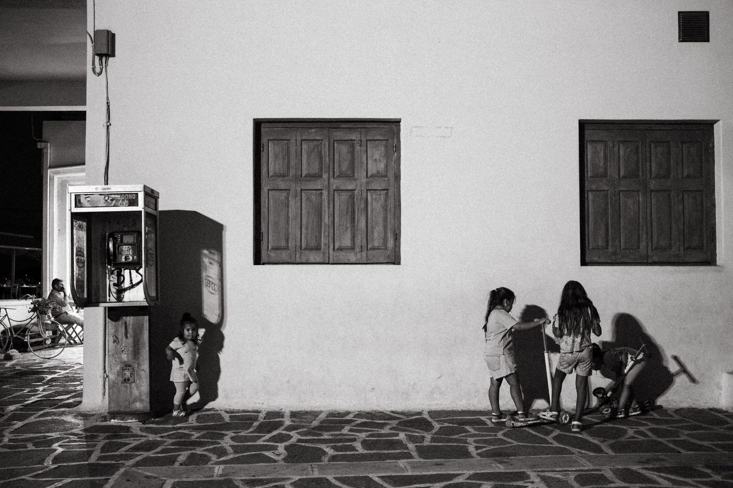 Black and white photo of a traditional Mediterranean building with stone floor patterns.