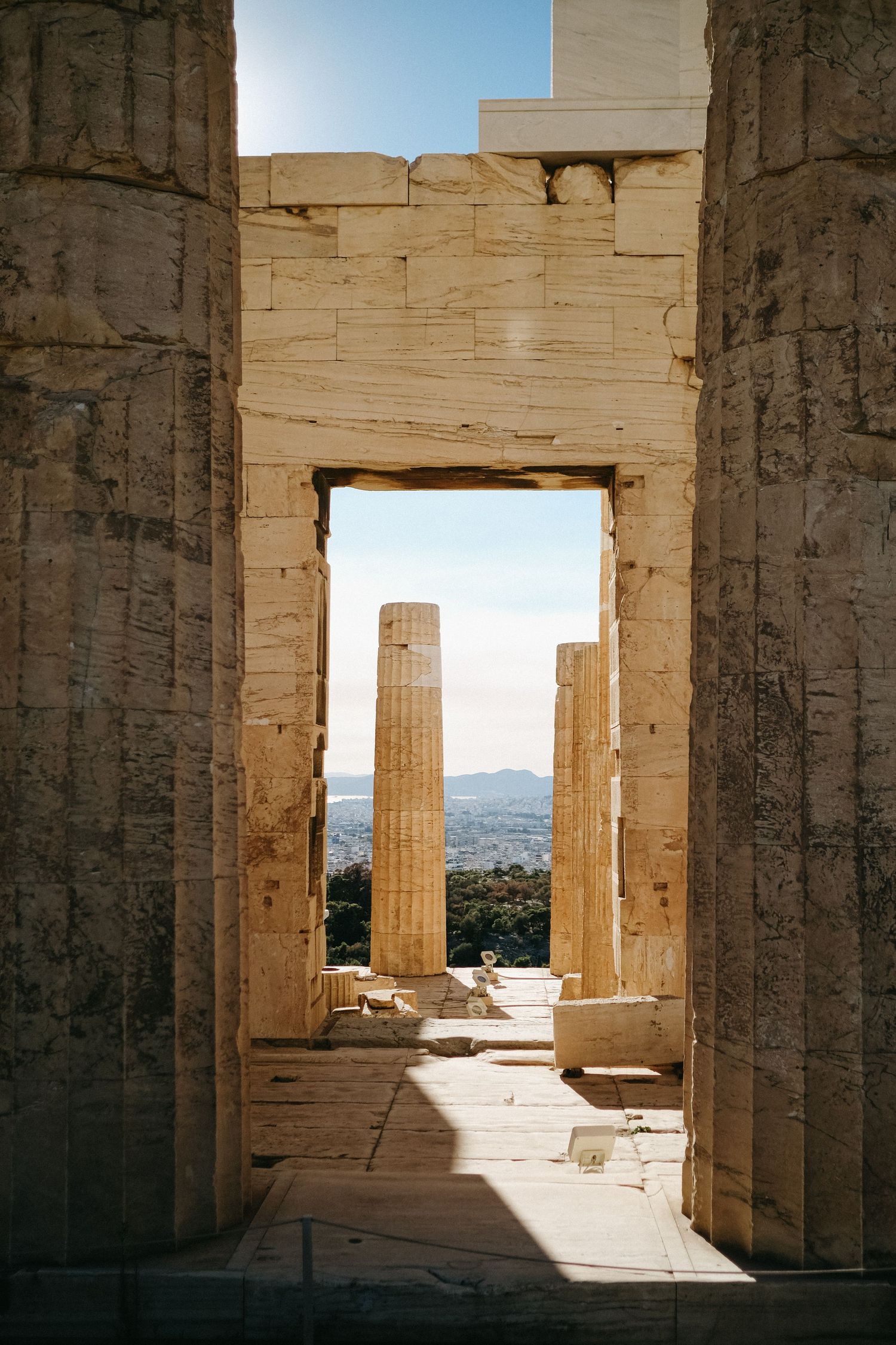 Ancient Greek columns frame a doorway at the Propylaea entrance of the Acropolis.