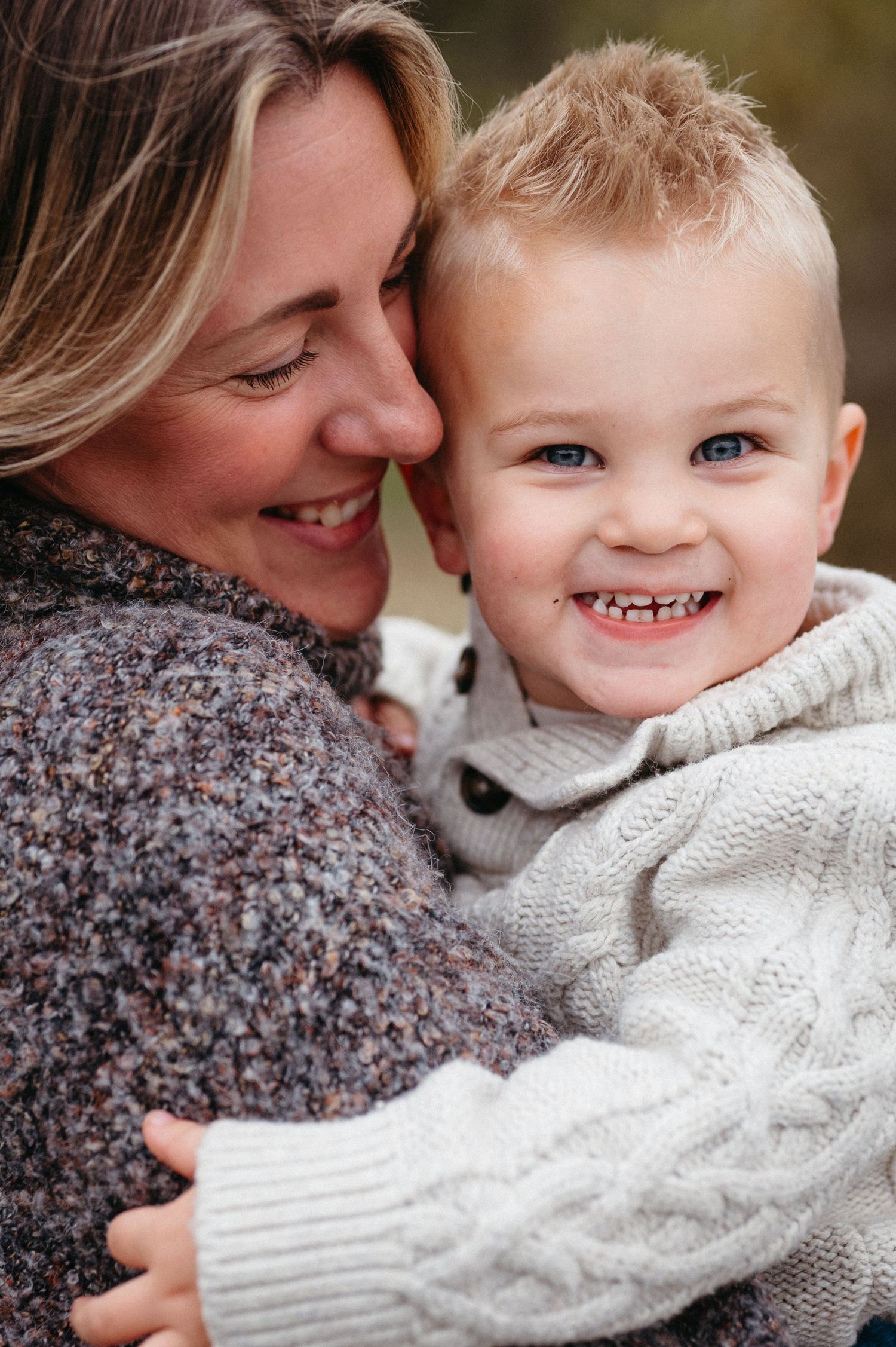 A heartwarming sequence of candid moments showing tender interaction between parent and child in matching knit sweaters.