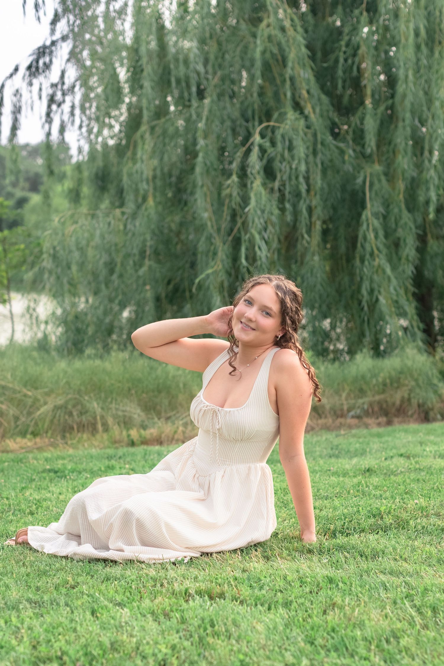High school senior smiling during her St. Louis senior photos at Forest Park. Authentic senior photography by Faith’s Flicks. Book today!