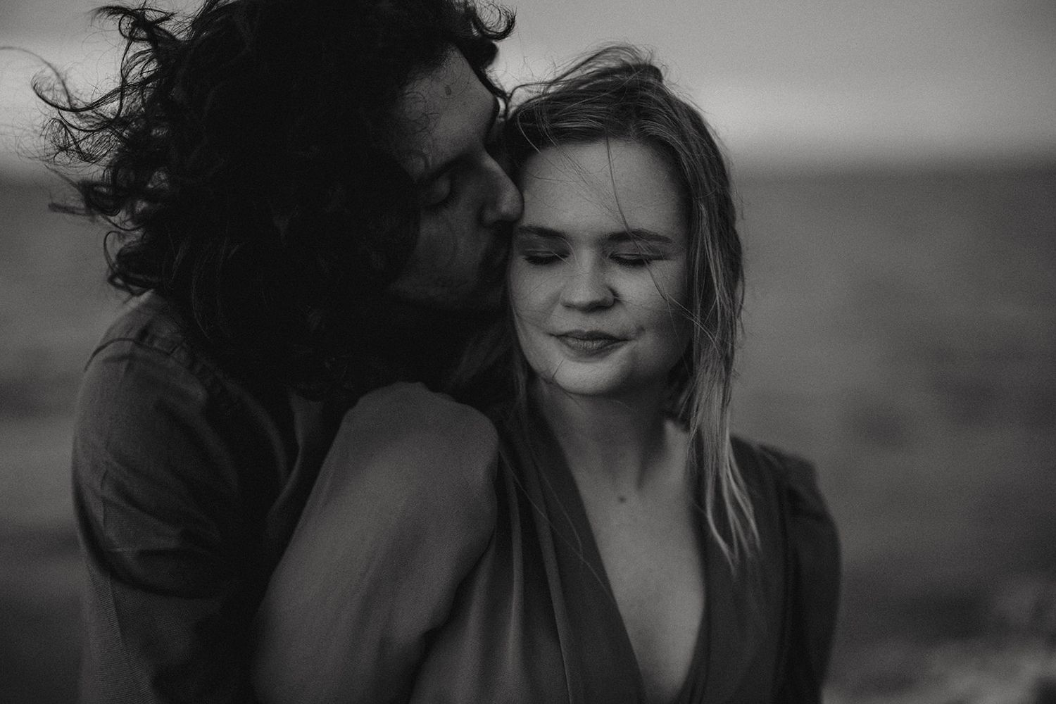 An intimate monochrome photograph of a couple with windswept hair against a soft background in Cleethorpes.