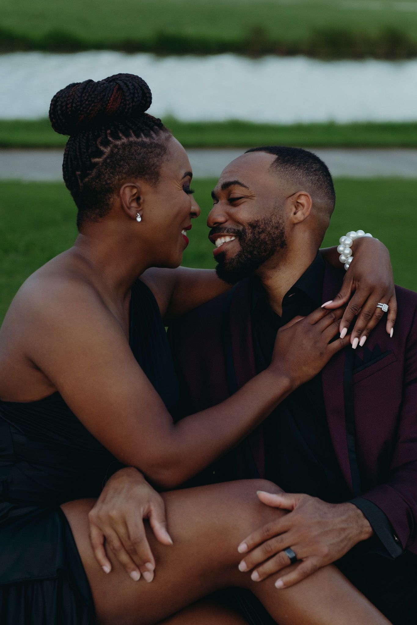 Intimate outdoor engagement session capturing joyful laughter and embraces.