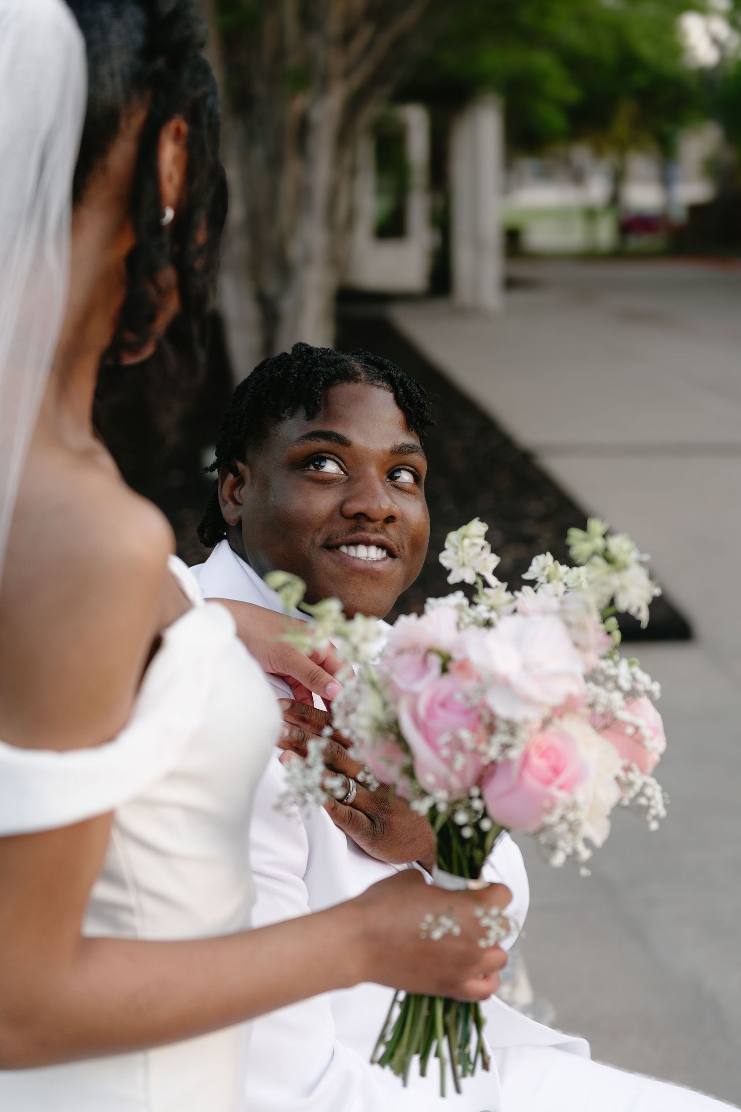 Beautiful bouquet of pink and white flowers held during wedding celebration.