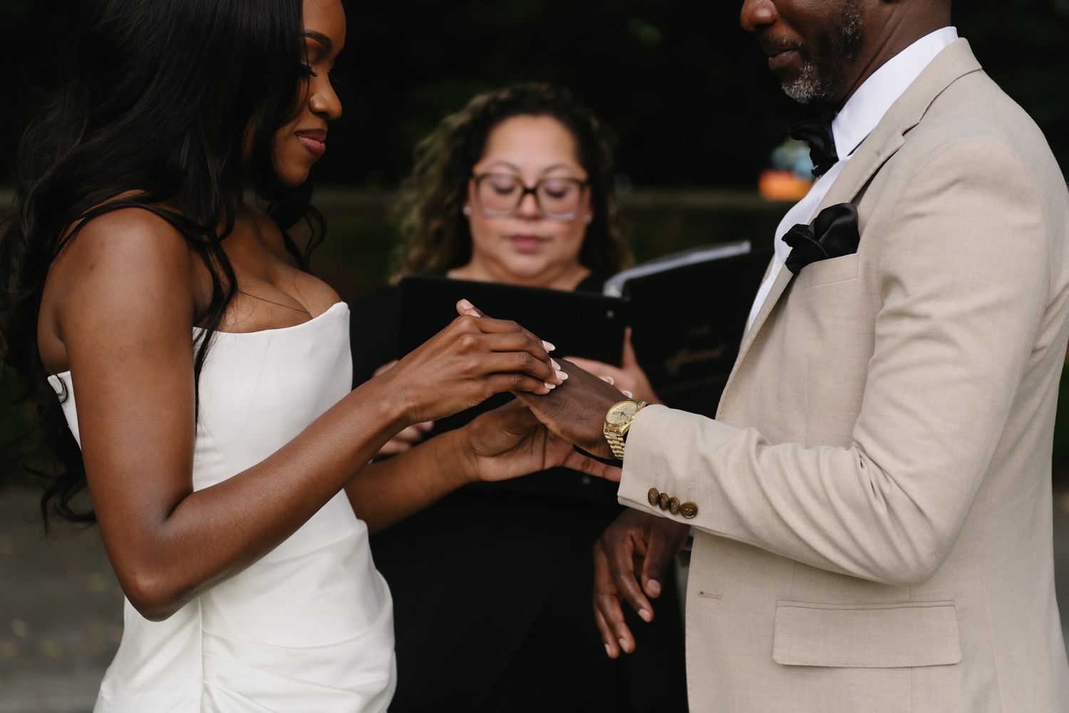Intimate wedding ceremony moment under garden archway.