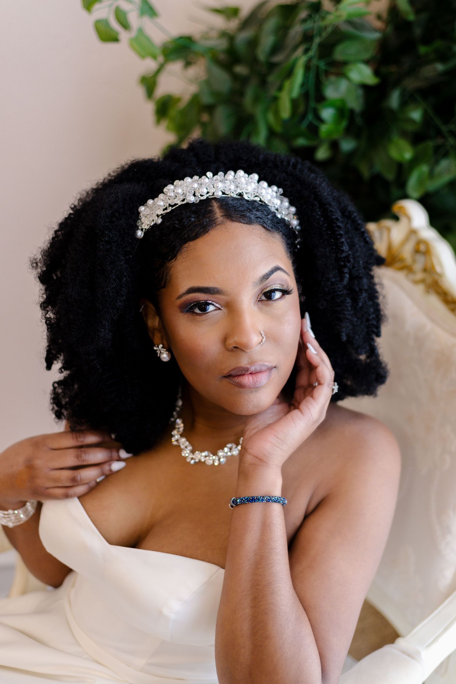 Elegant bridal portrait with sparkly hair accessories and white attire.