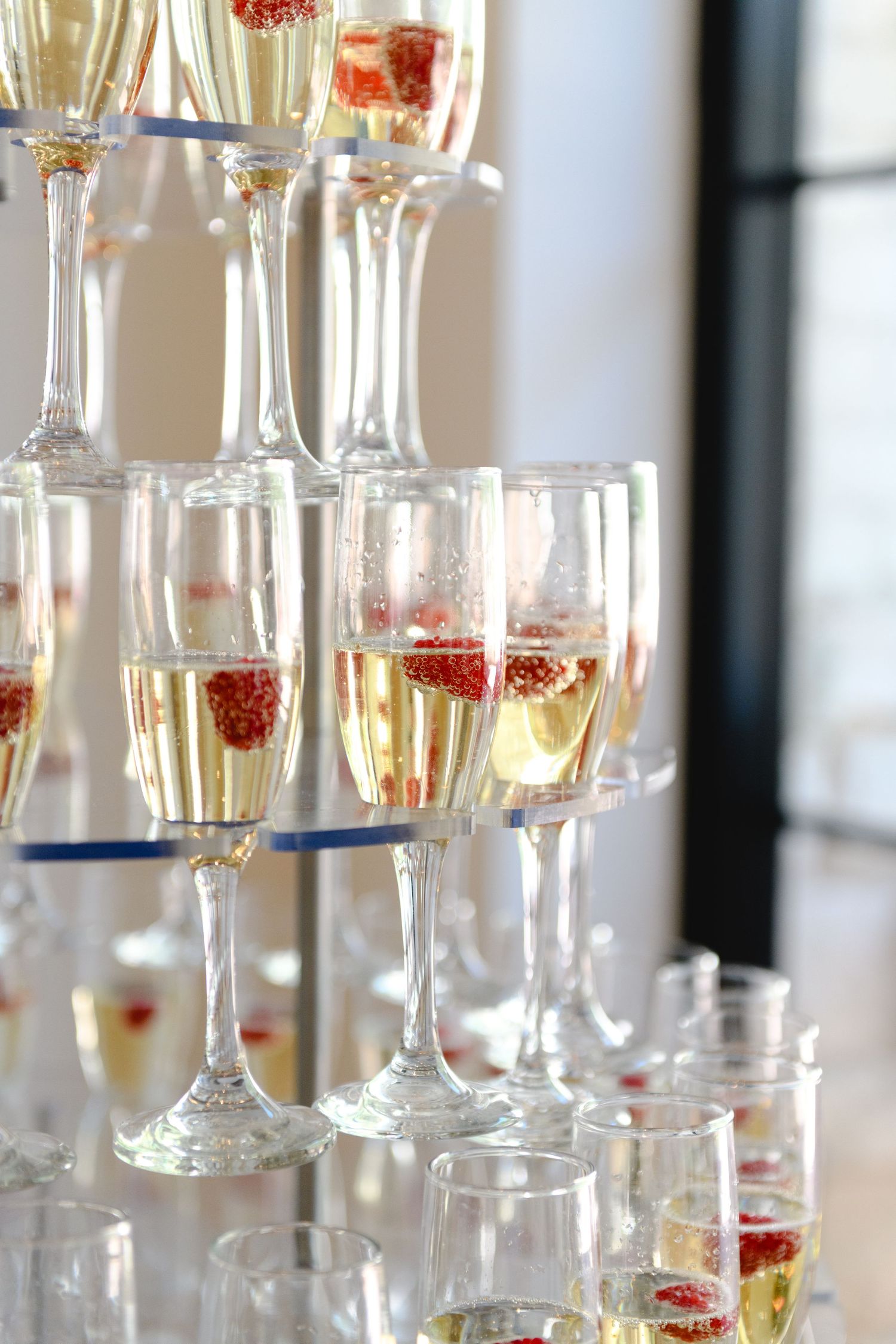 Champagne flutes with strawberries arranged in elegant display at event.