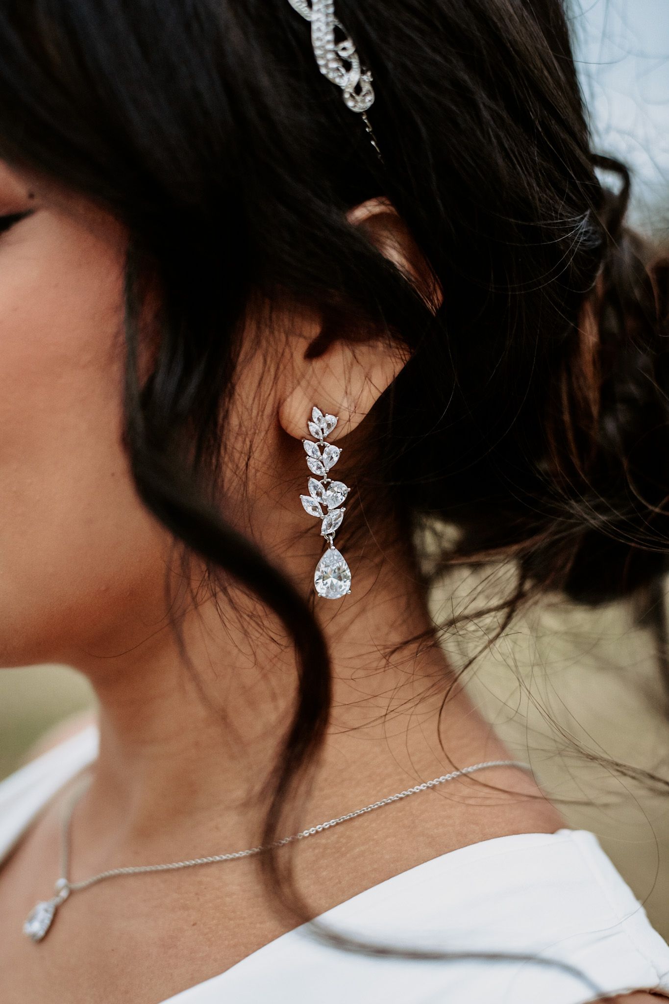 Close-up of sparkling crystal bridal earrings and jewelry.