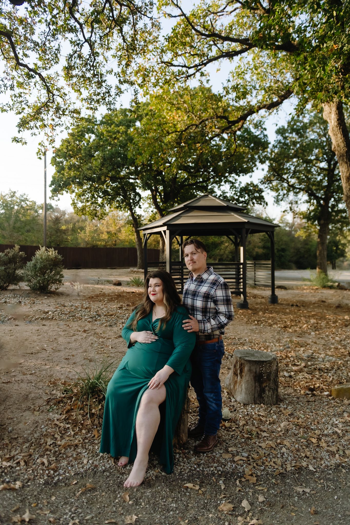 Couple sitting together on a bench in an autumn park setting.
