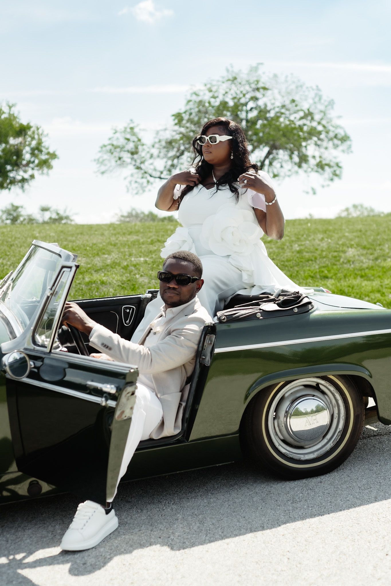 Classic vintage car photoshoot featuring a green convertible on a sunny day.