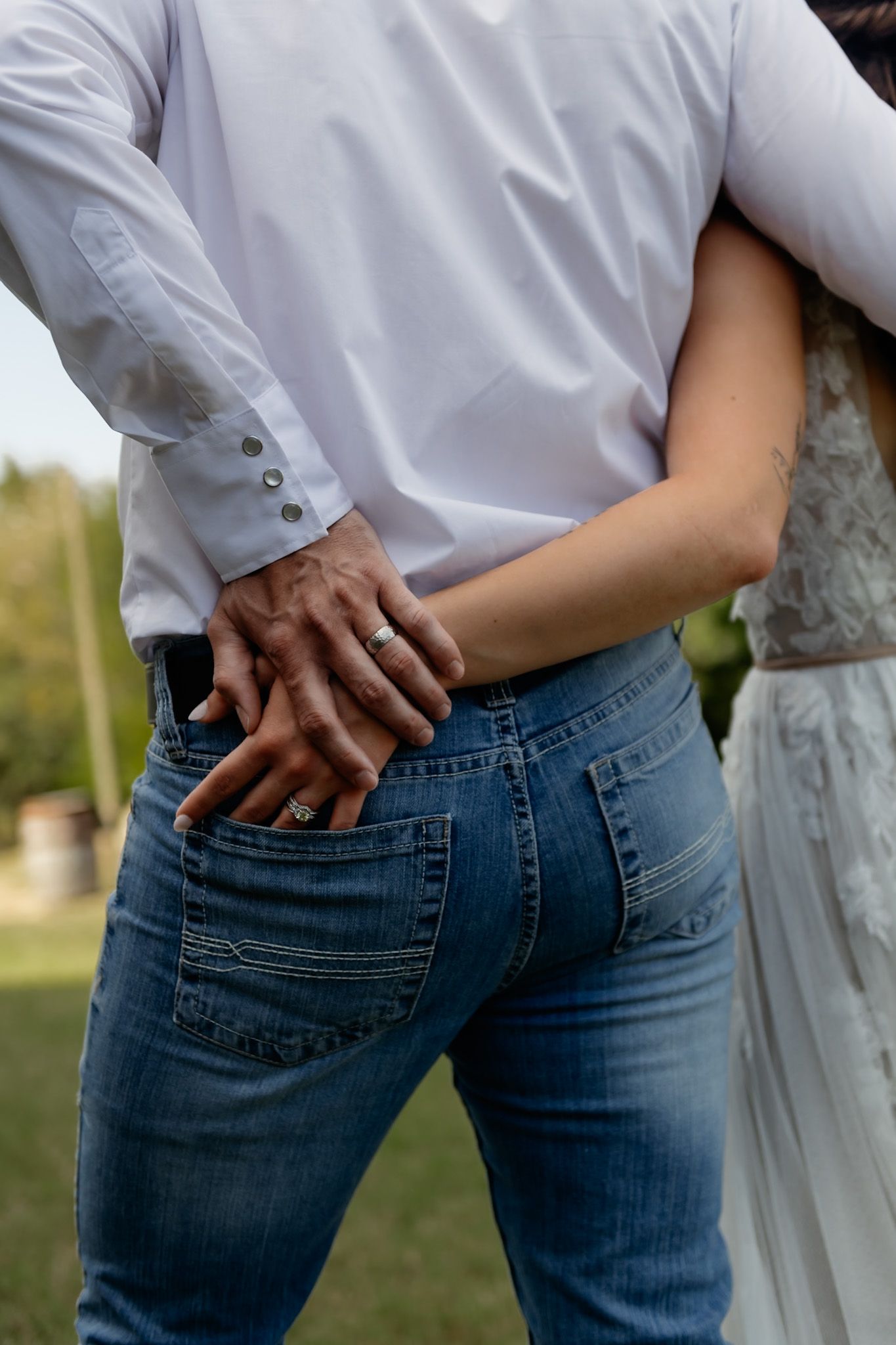 Close-up shots of hands in back pockets of blue jeans during casual photoshoot.
