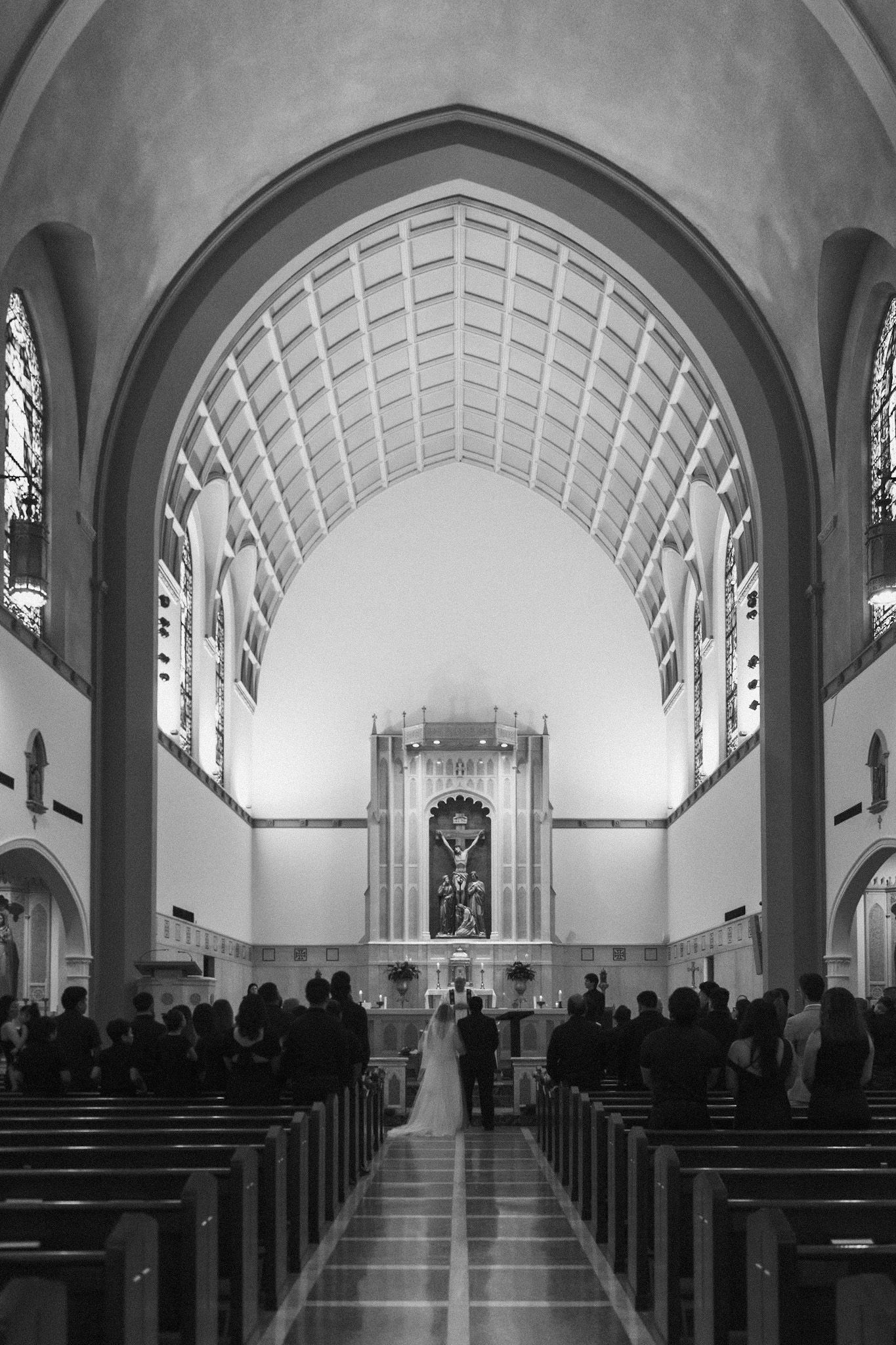 Interior of a church sanctuary with vaulted ceiling and arched windows.