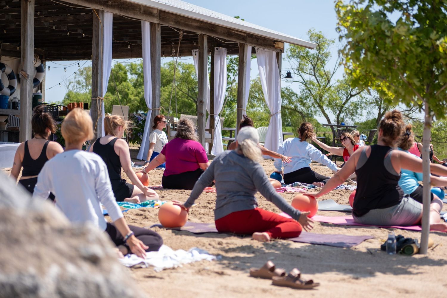 Pilates Class during a wellness retreat, Simply Well Retreat, on a beach in Nebraska.
