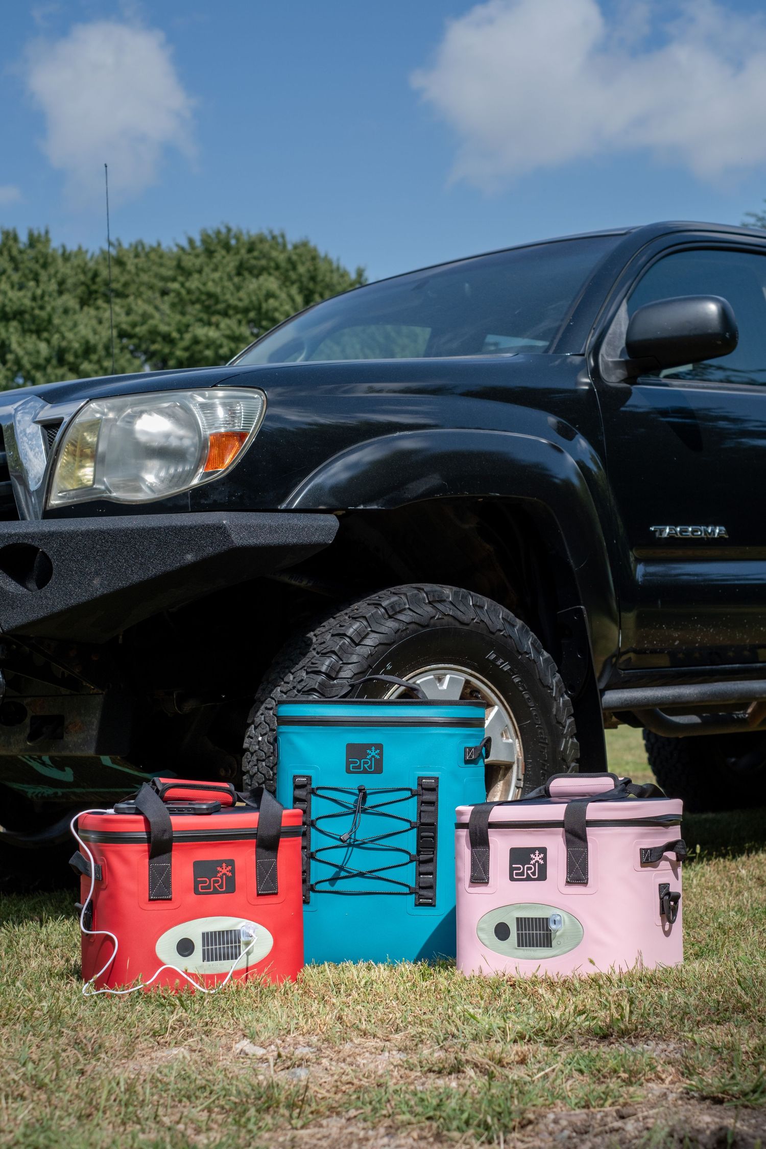Three PRI coolers are shown in front of a Tacoma pickup.