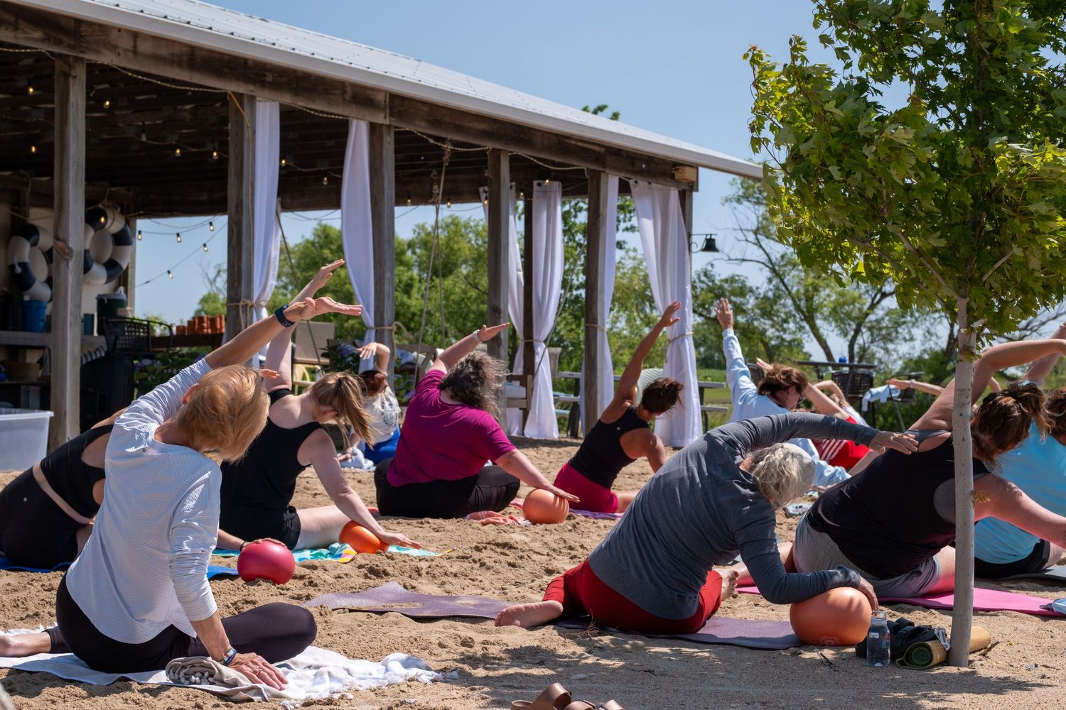 Pilates Class during a wellness retreat, Simply Well Retreat, on a beach in Nebraska.