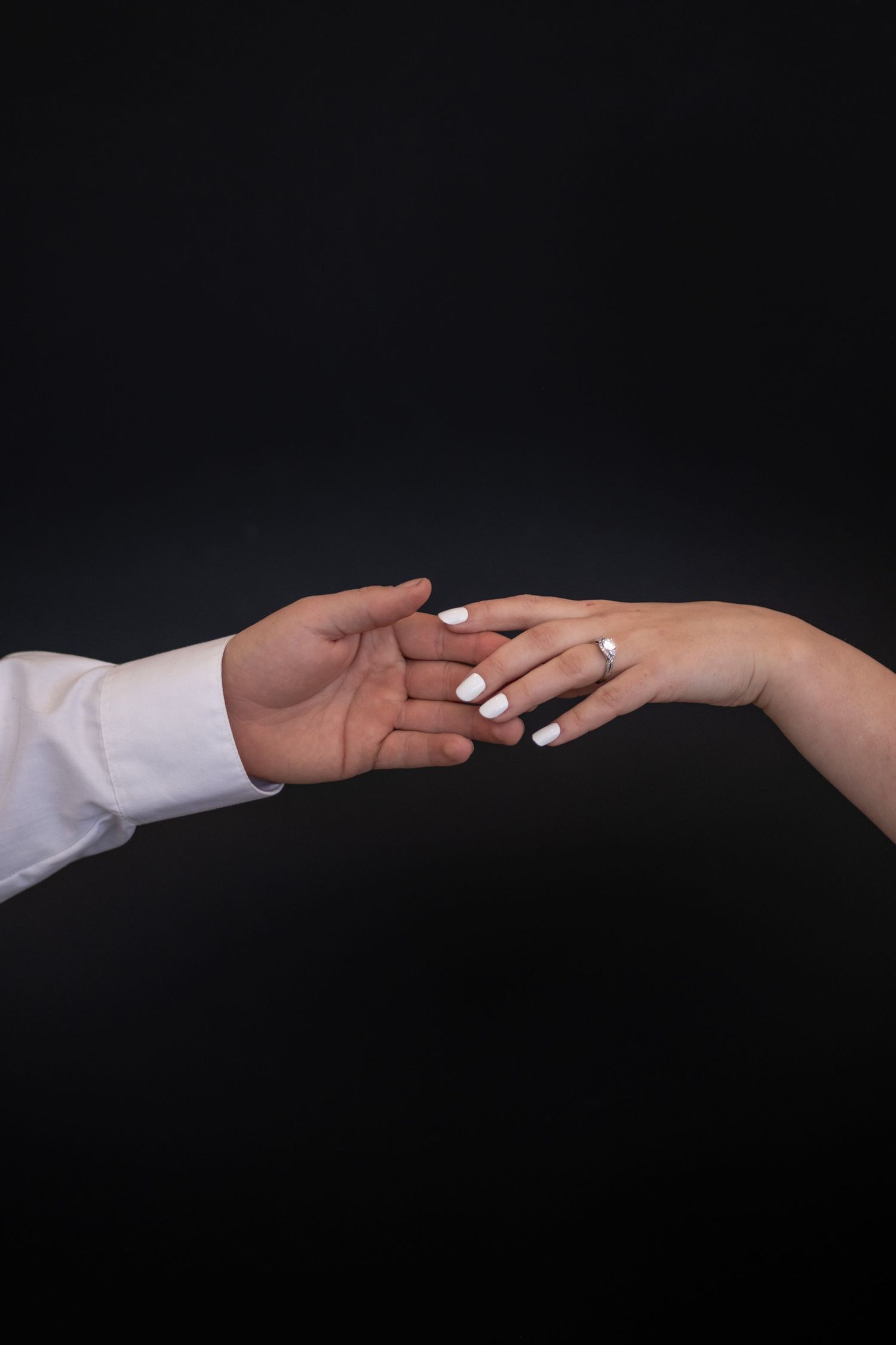 Hands outstretched to feature a beautiful wedding ring during a styled shoot.