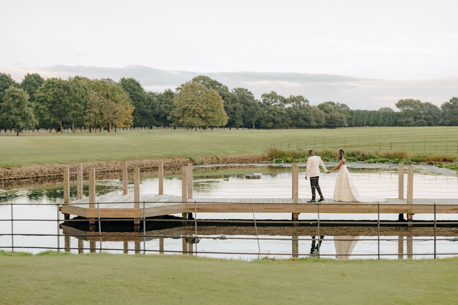 A scenic lakeside dock wedding venue with wooden posts and railings.