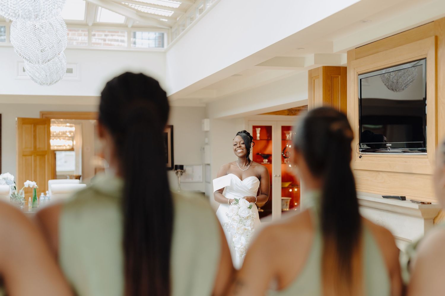 Interior view of an elegant wedding venue with wooden beams and natural lighting.
