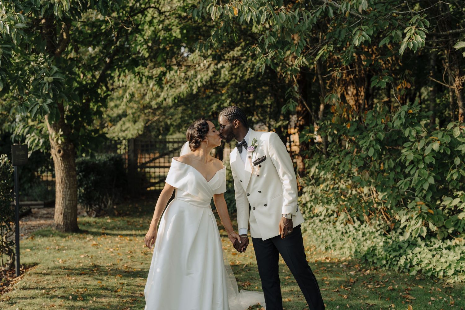 Outdoor wedding photography session among lush green trees and natural scenery.
