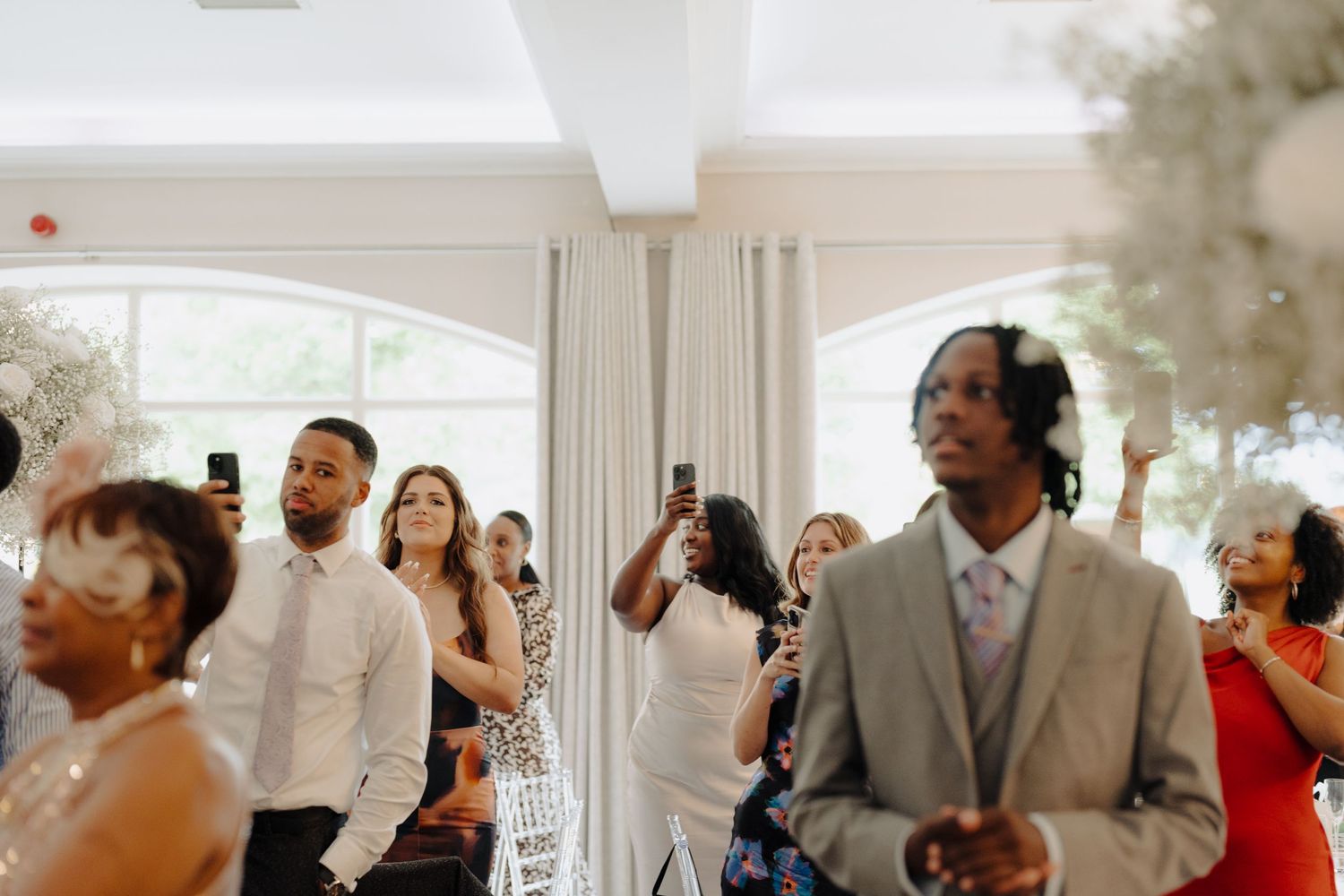 Wedding guests dancing and celebrating during the reception party.