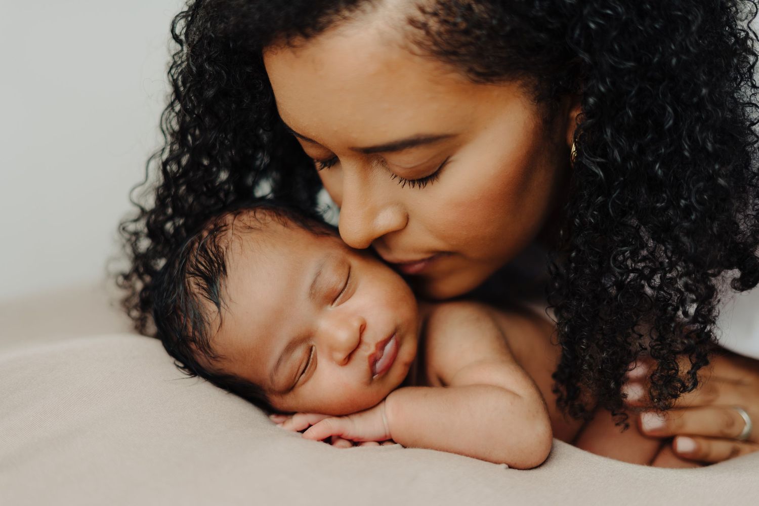 Intimate black and white portraits of tender moments between parent and baby.