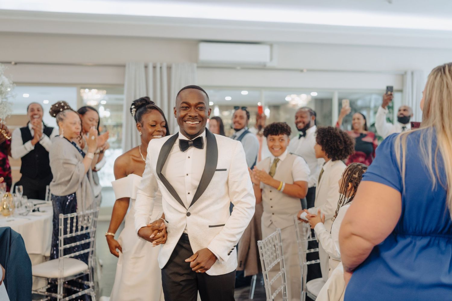 Wedding guests enjoying themselves on the dance floor during reception celebrations.