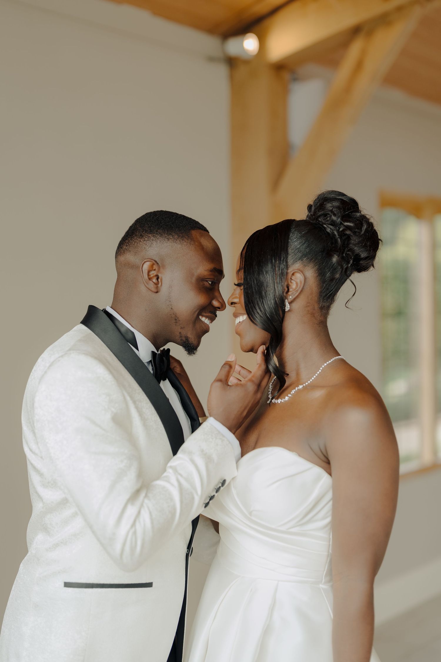 Intimate wedding portraits captured indoors showing joyful expressions and laughter.