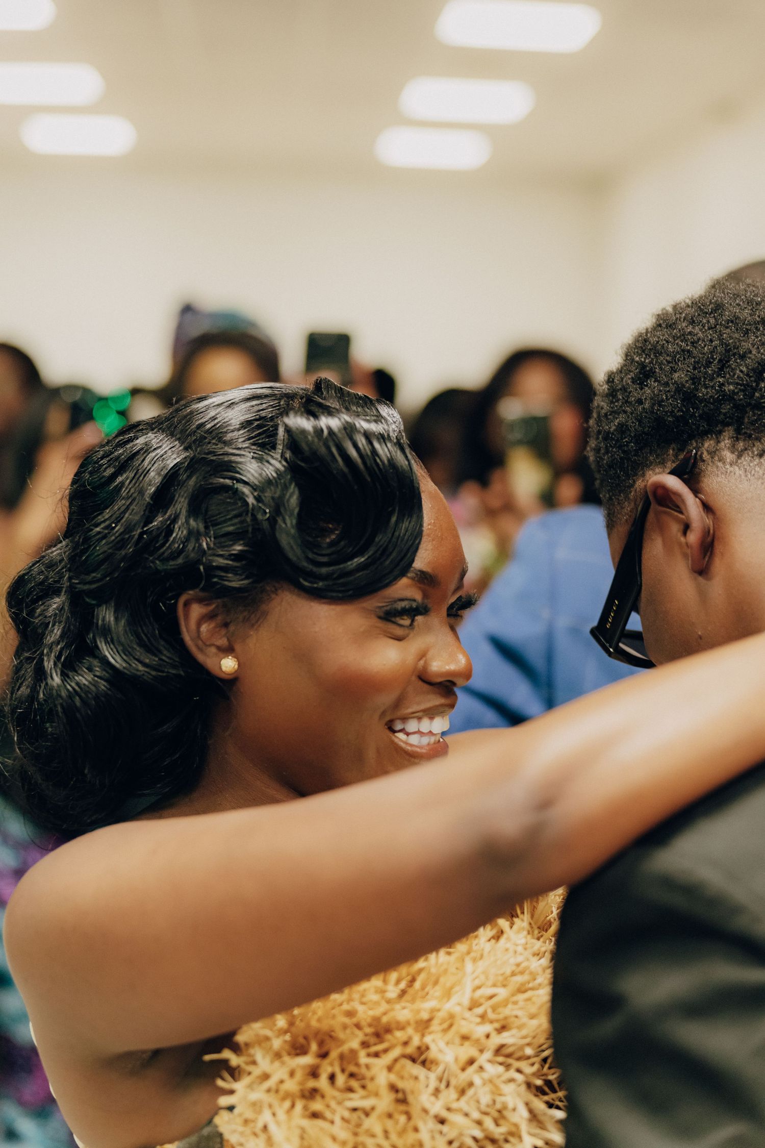A close-up shot of two people sharing a joyful embrace during a celebration.