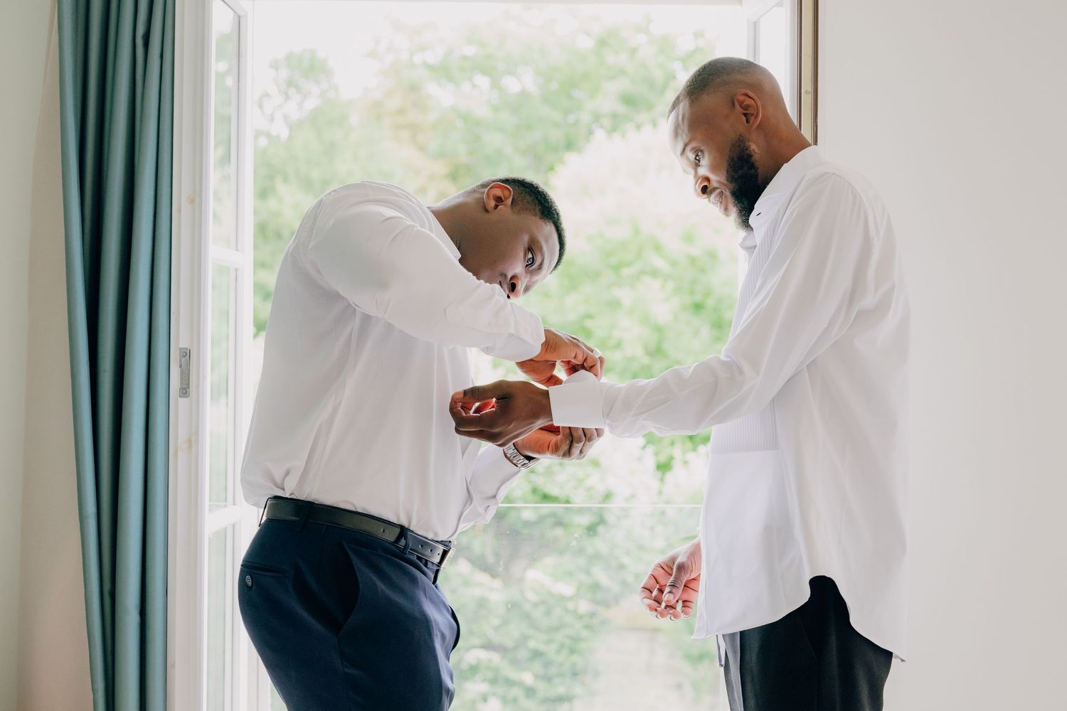 A sequence of getting ready photos showing someone in a white dress shirt and dark pants in a bright room.
