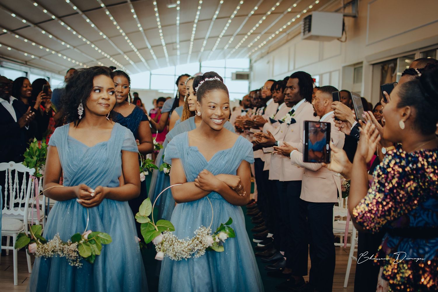 Bridesmaids in light blue dresses celebrate during wedding reception.