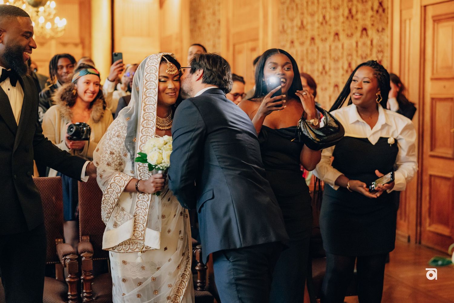 Joyful wedding ceremony moment in an ornate indoor venue with celebratory gestures.