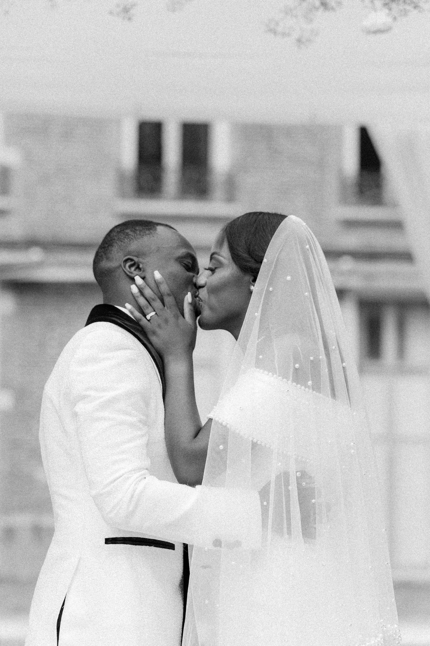 Romantic black and white wedding moment captured during outdoor ceremony.