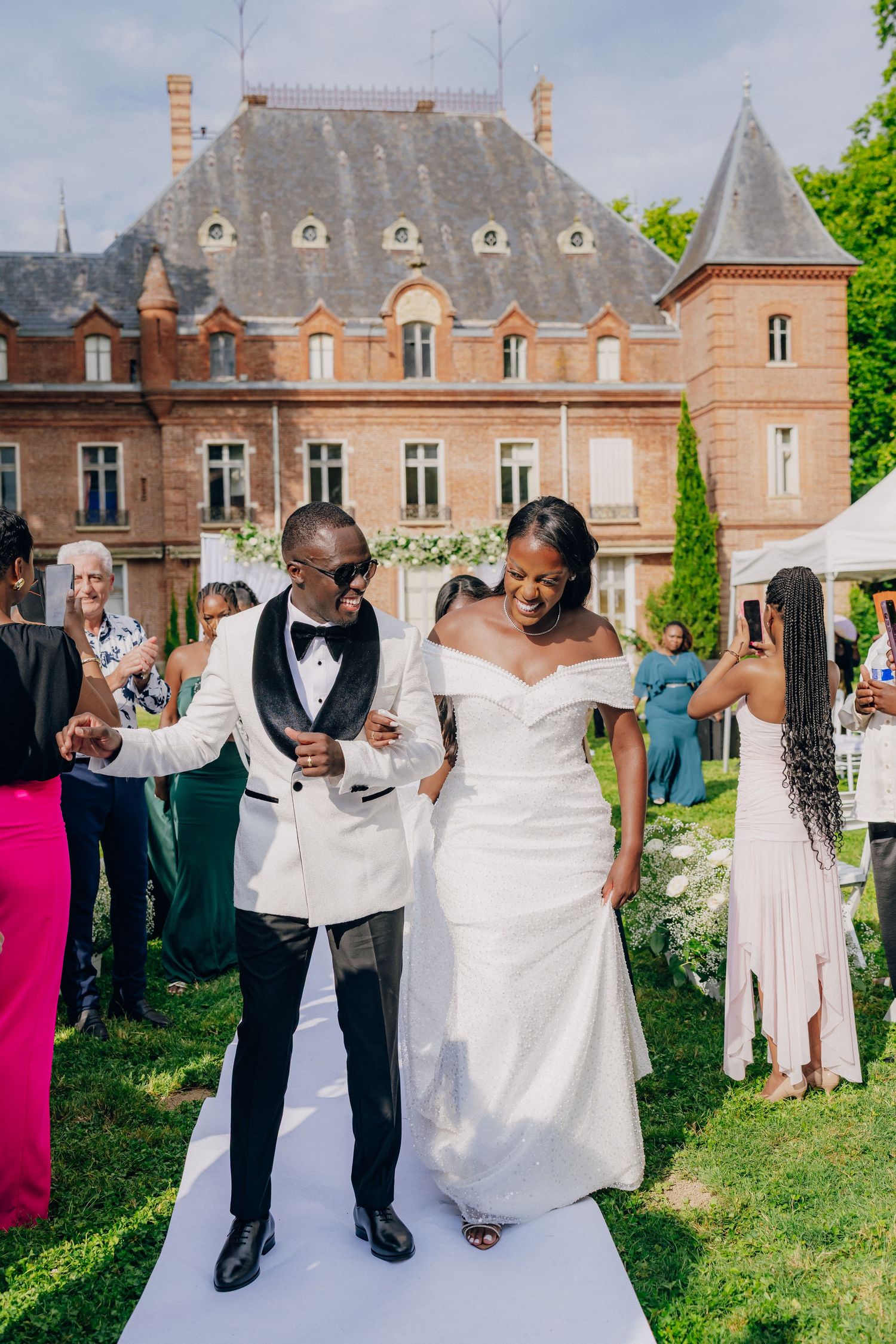 Wedding celebration at an elegant chateau with manicured gardens and classic architecture.