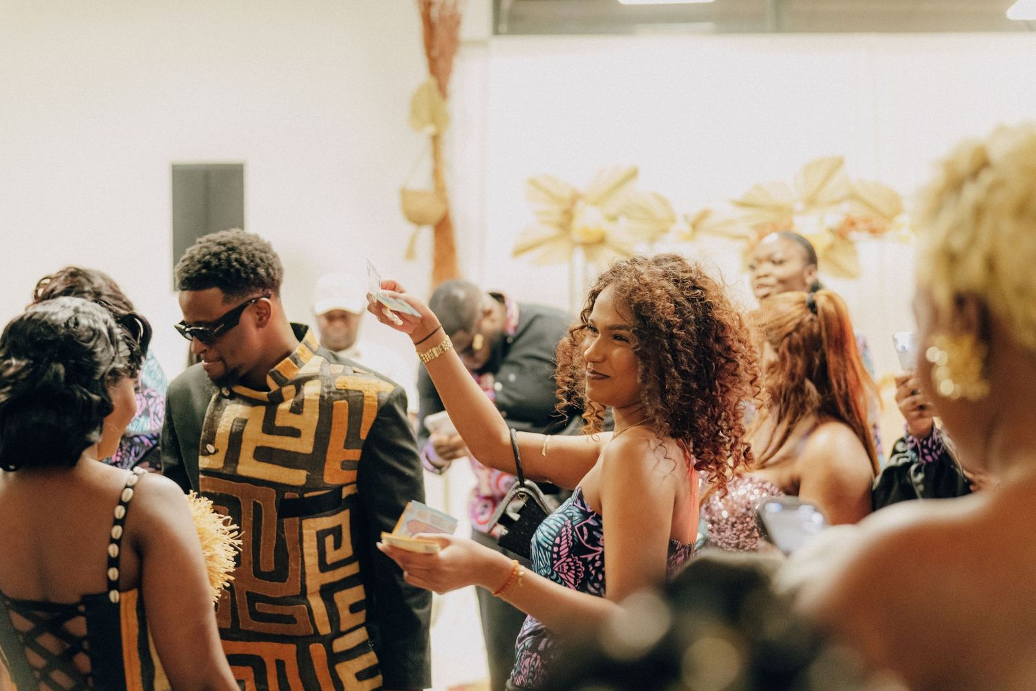A lively group of people dancing and enjoying themselves at an indoor social gathering or party.