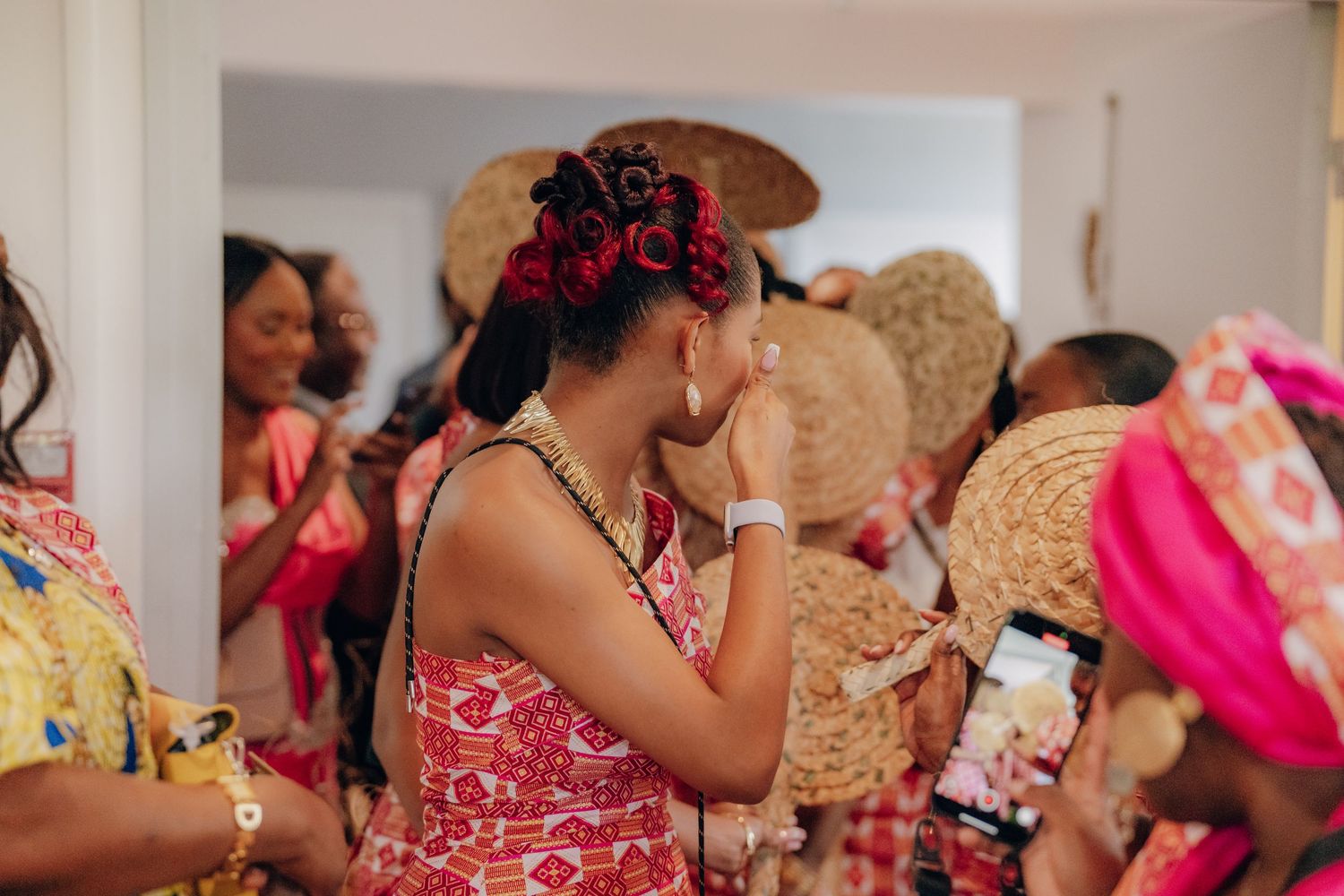 A group of people in colorful traditional Indian attire gather at a festive celebration or wedding event.