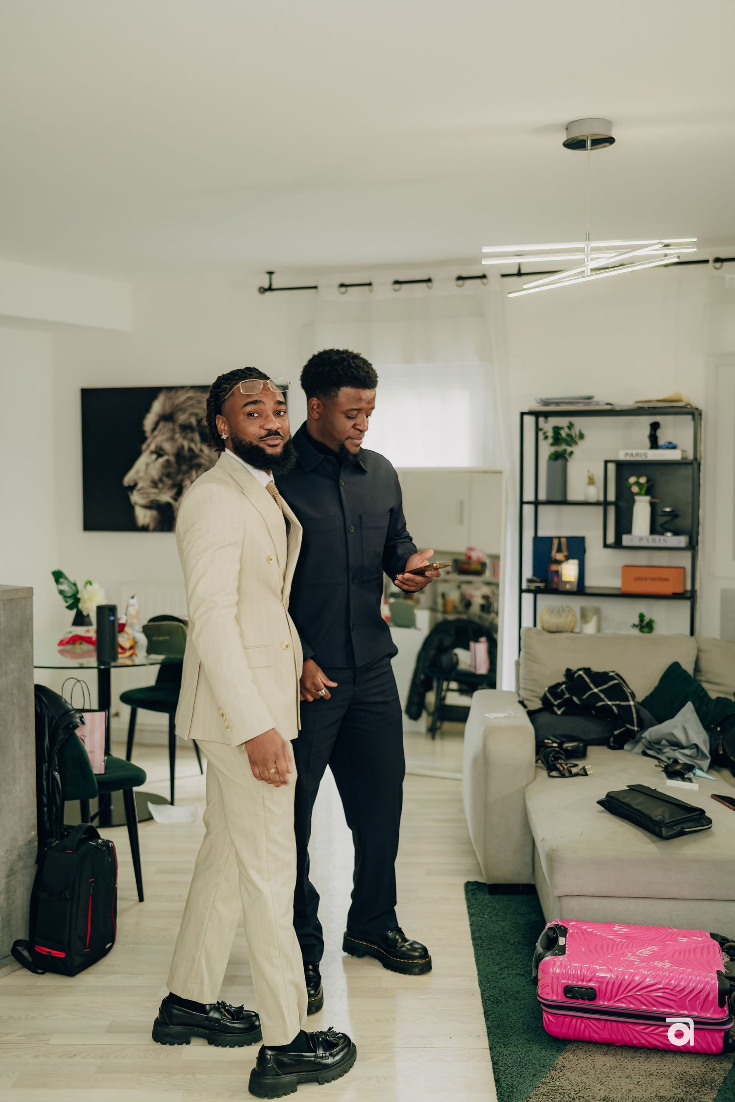 Two people in a modern apartment sharing a joyful moment while dressed in contrasting black and white outfits.