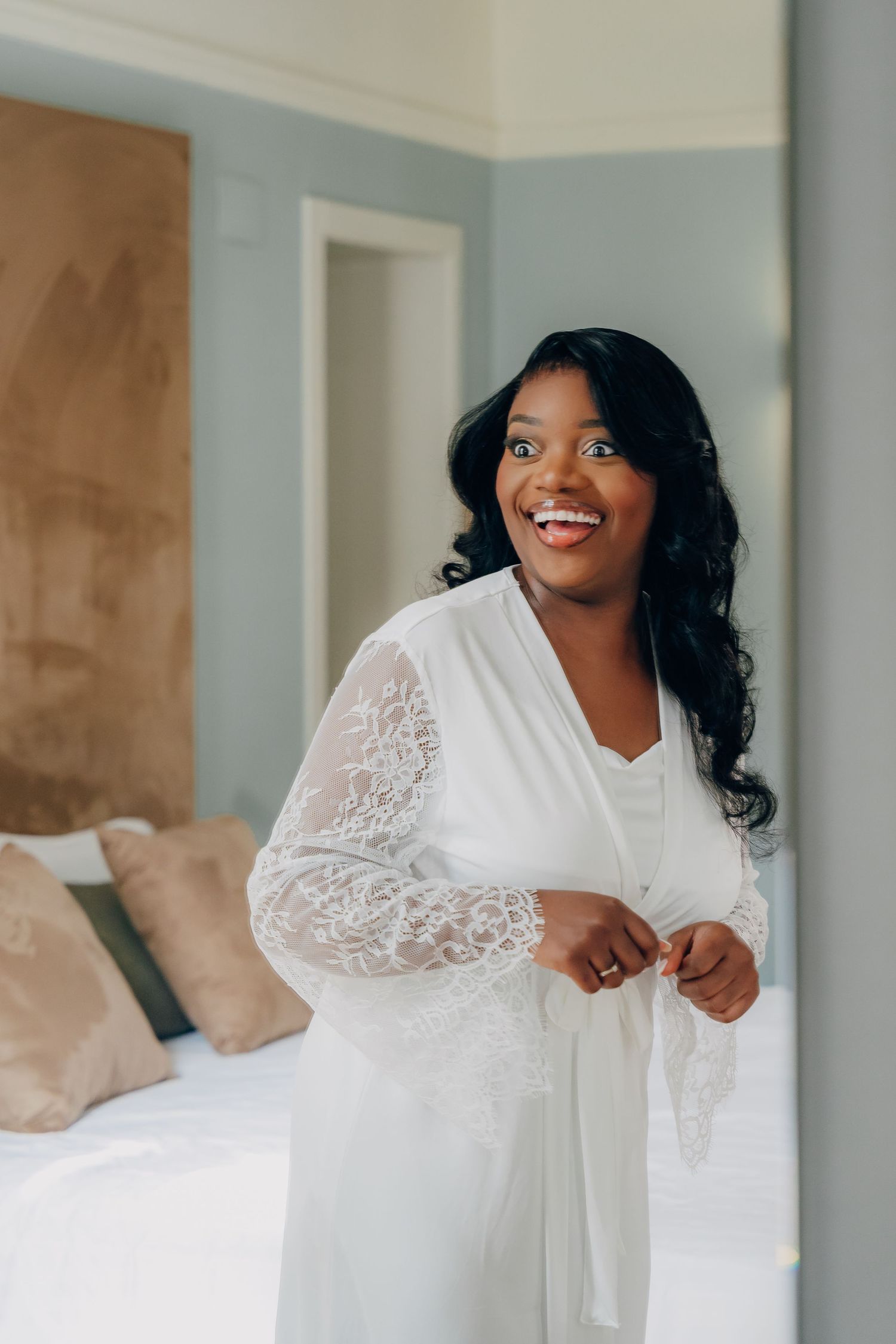 Wedding morning preparations in a bright room with white lace details.
