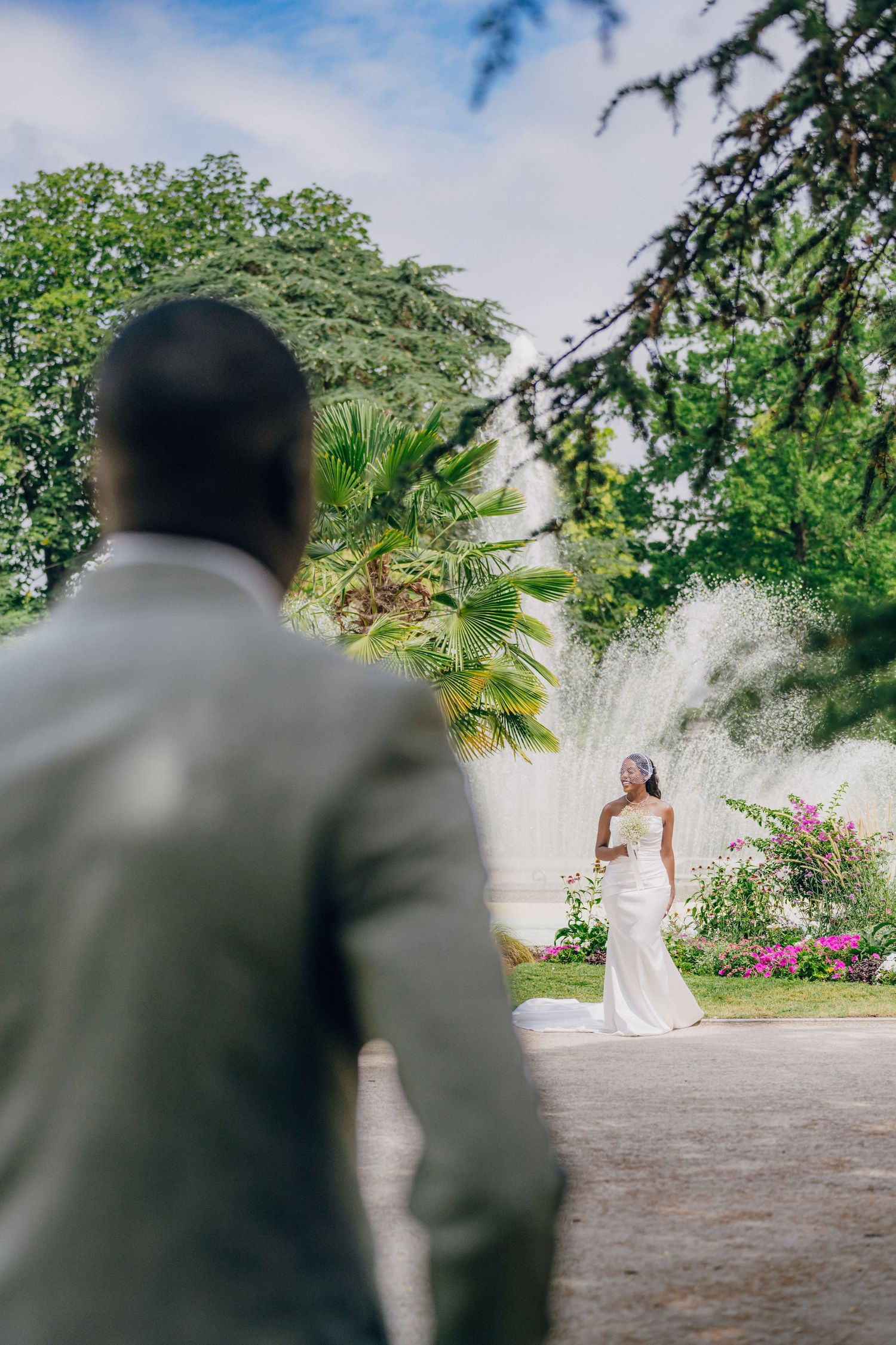 A wedding first look sequence showing a bride in white dress being revealed to the groom in a garden setting.