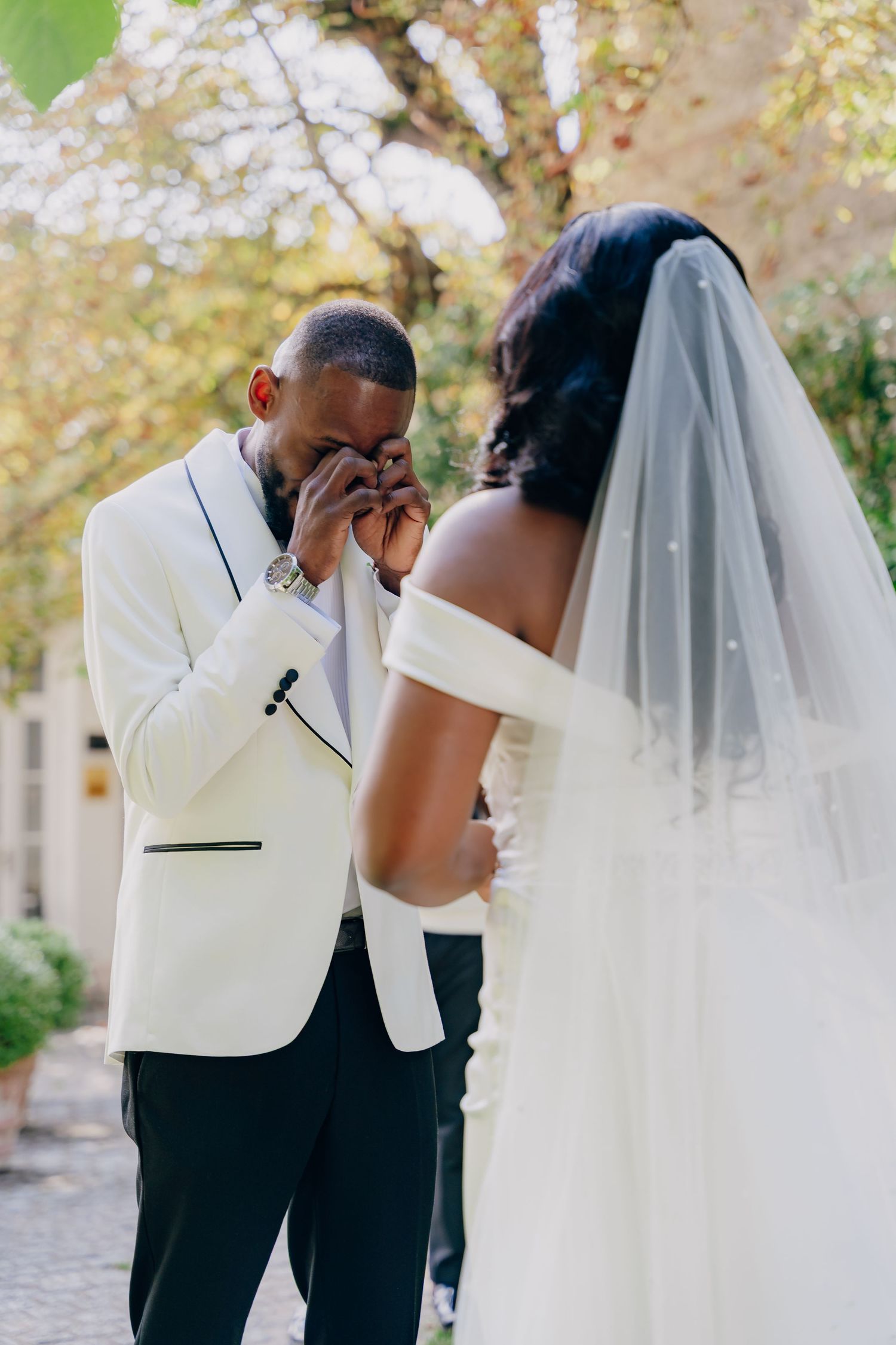 A romantic wedding couple shares intimate moments in a series of tender embraces beneath a veil.