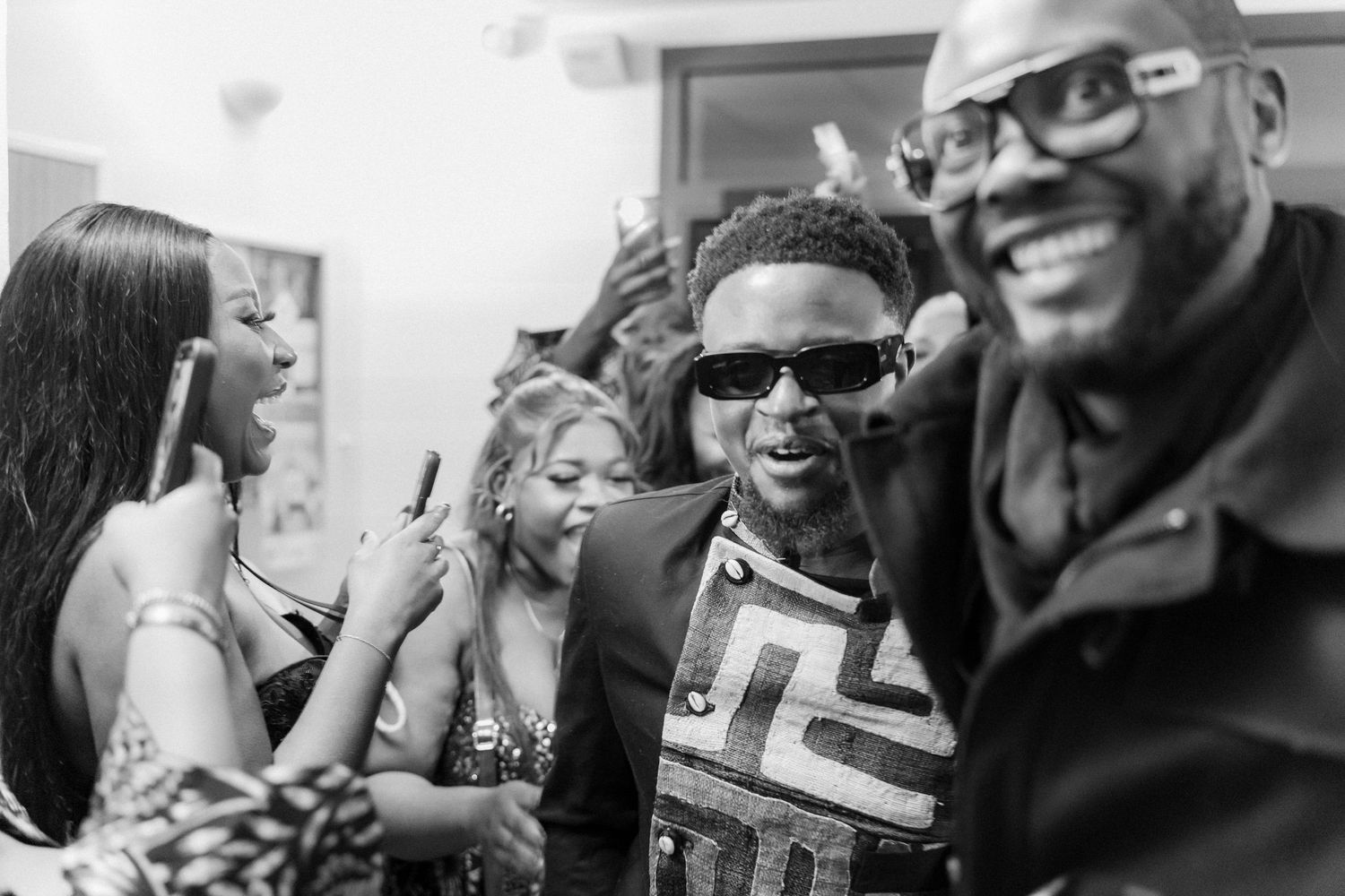 A group of people enjoying a social gathering, laughing and having fun together in black and white.