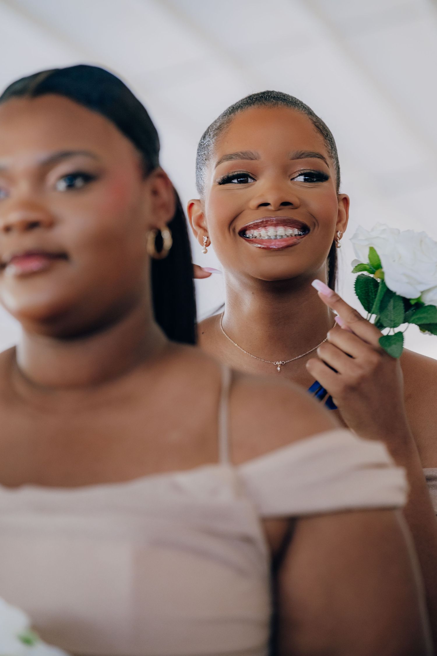 A series of close-up shots showing joyful expressions and smiles in elegant makeup and formal attire.