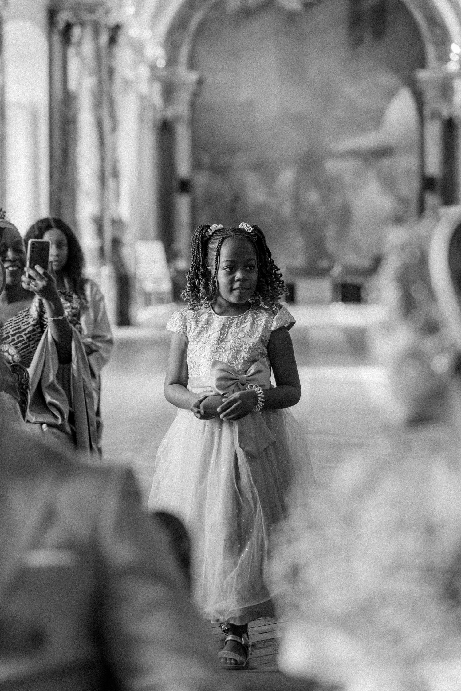 Black and white photo sequence showing movement across an ornate indoor venue.