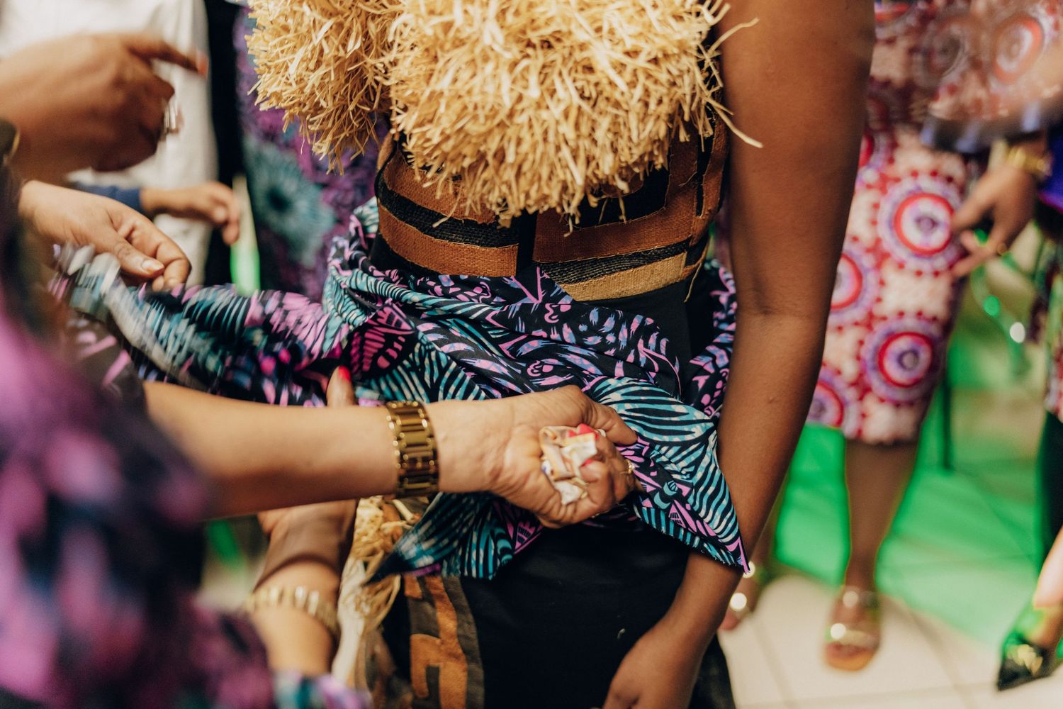 Close-up of colorful printed fabric and accessories at a social event.