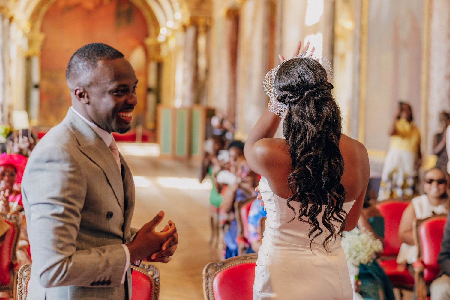 Celebration in a luxurious baroque palace hall with frescoed walls and gilded details.