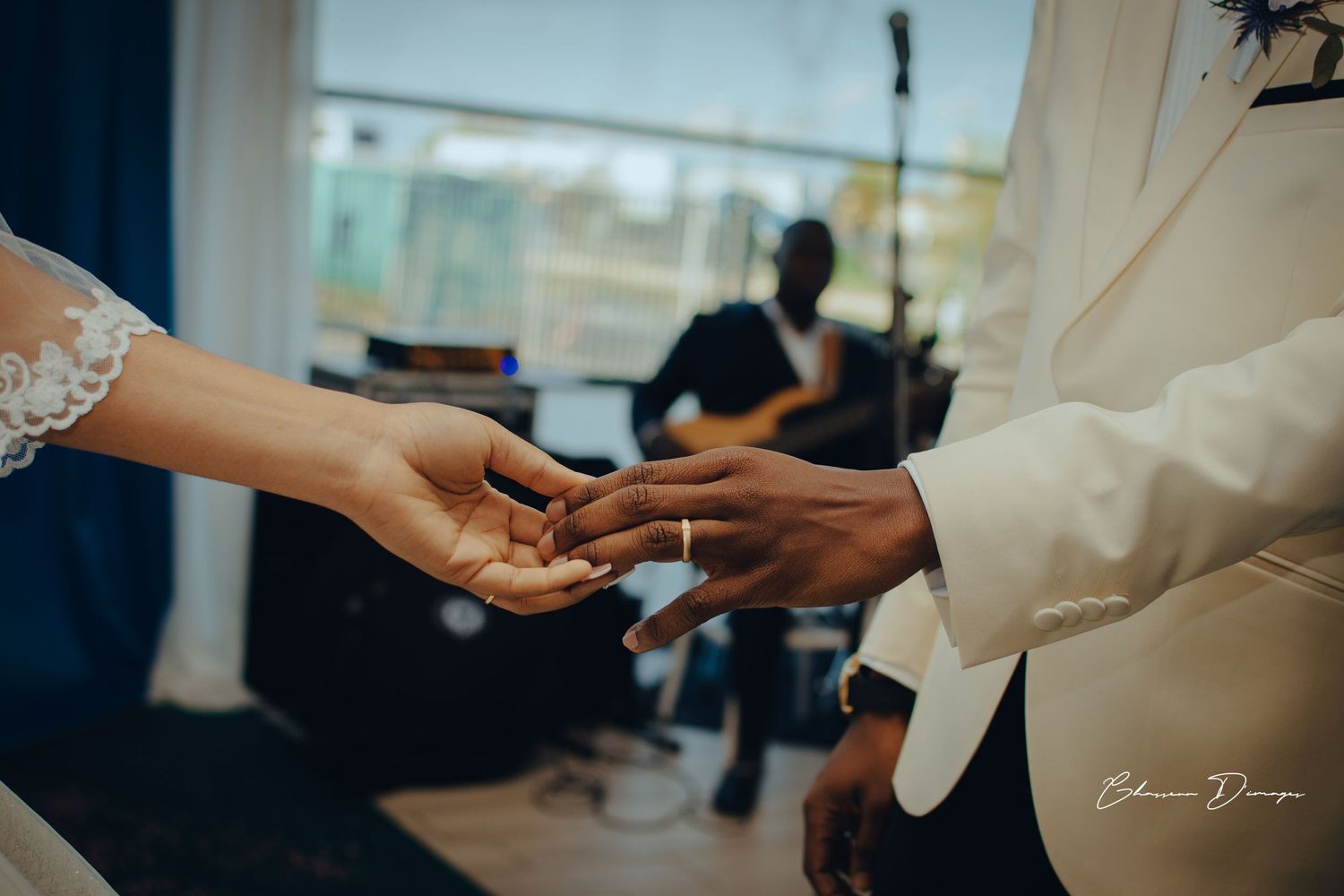 Exchange of rings during wedding ceremony with elegant hands in focus.